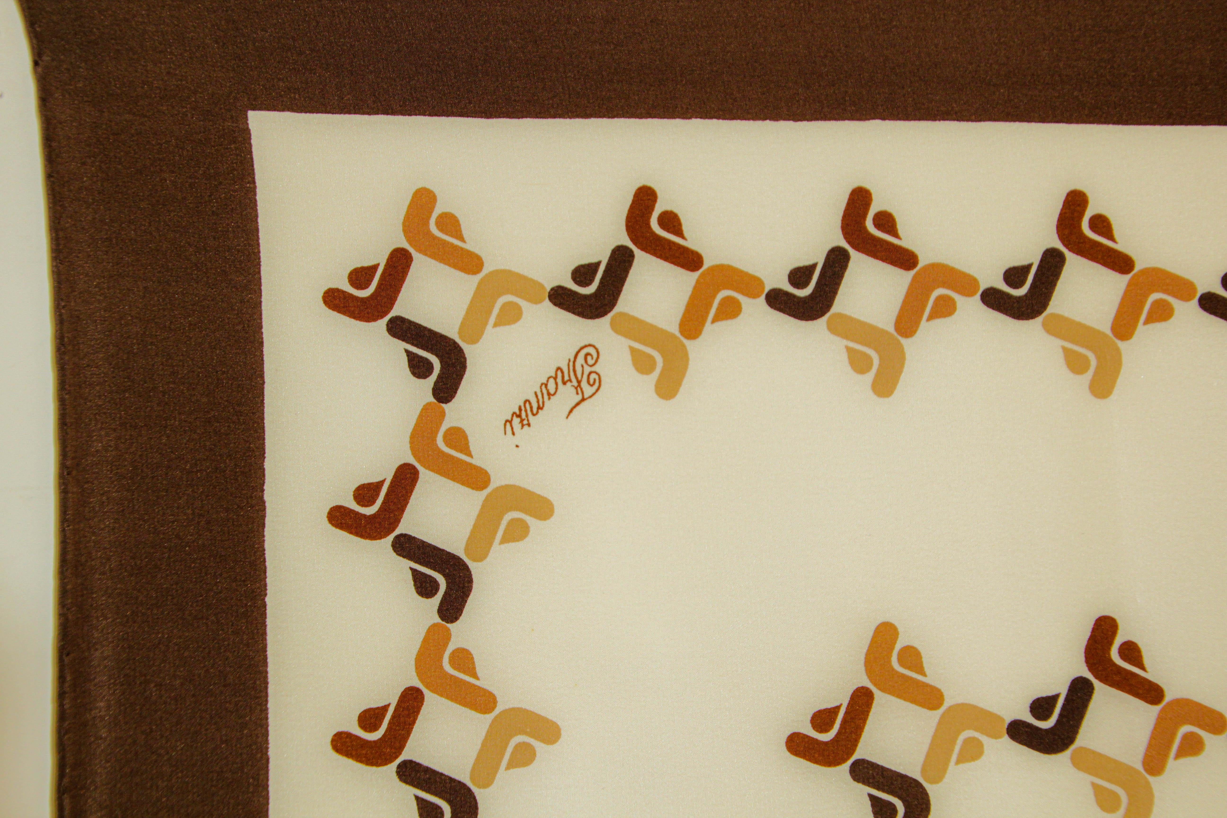  Franzi Brown and White Silk Square Scarf
This silk with mid century style post modern 1970s geometric print.
70s Franzi Brown, amber and white silk scarf with FF logo, signed on corners FRANZI.
Measurements : 33.5