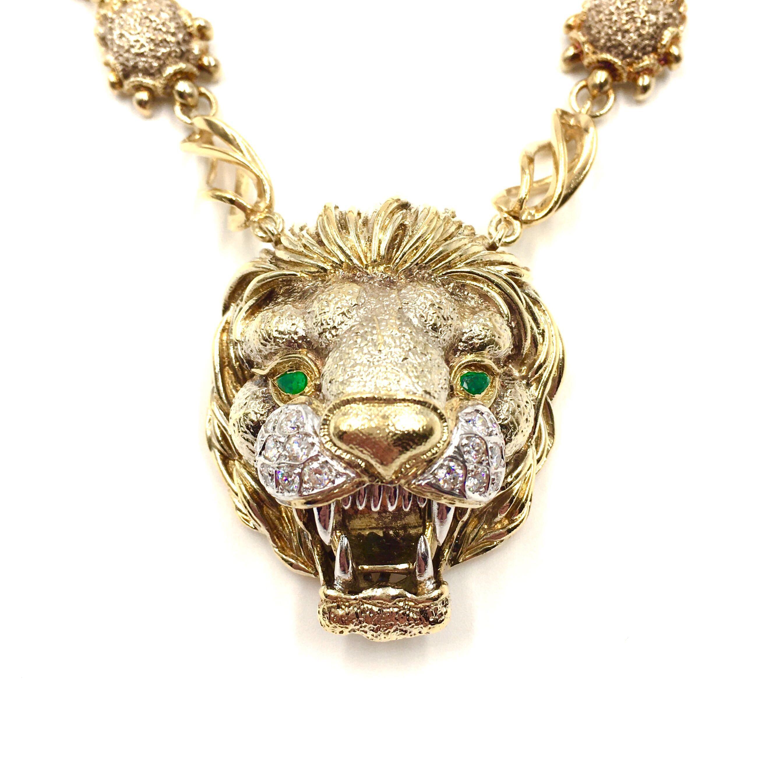 An 18 karat yellow gold, diamond and emerald necklace and pendant, Frascarolo, Italy. The long chain formed of textured lion’s paw links alternating with open spiral links centering a bold pendant of a three dimensional lion’s head, the whiskers set