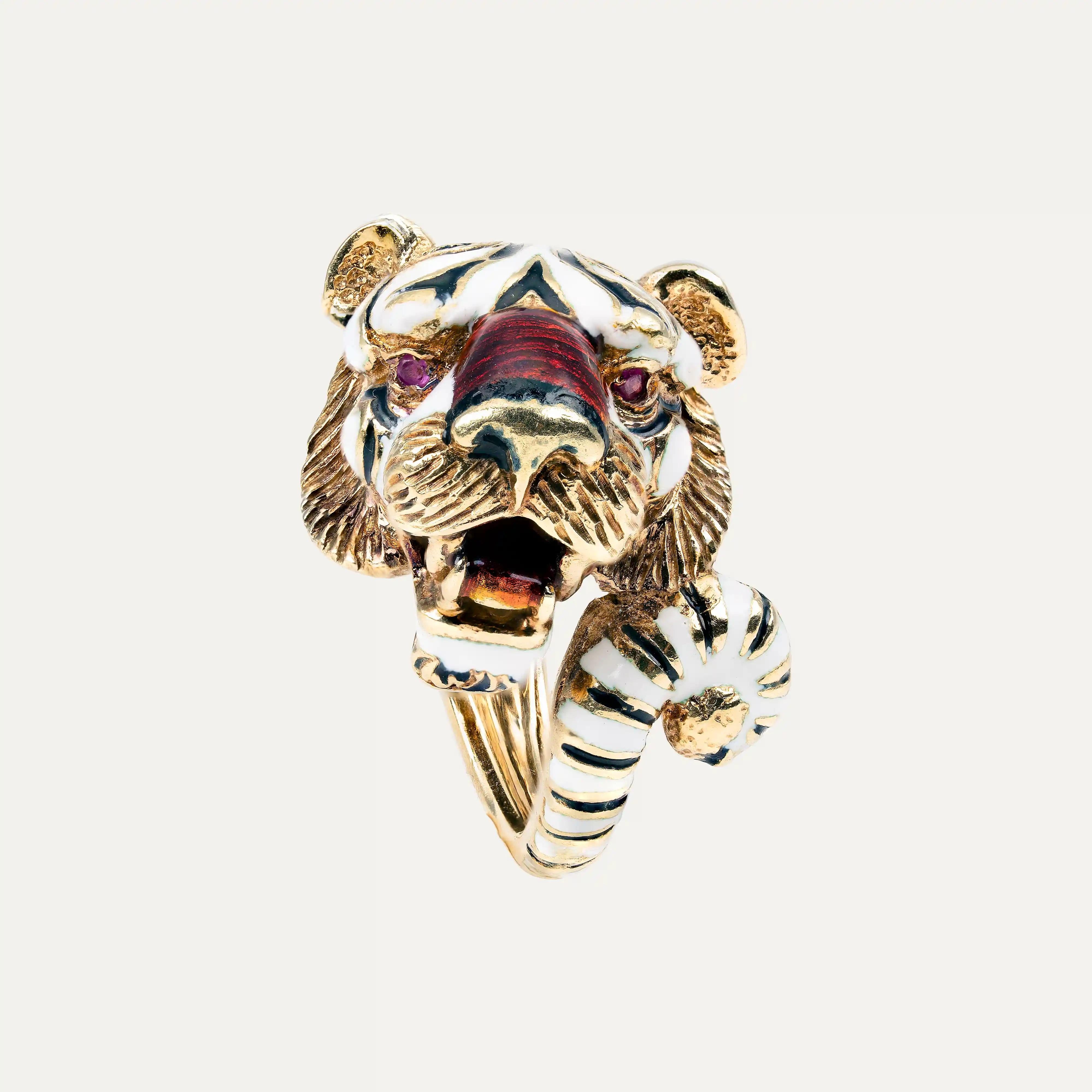 
18kt – 750‰ yellow gold tiger ring, with white, black, and red enamelled stripes, eyes set with 2 cabochon rubies. From the “Fierce Beast” Collection by the Italian jeweller and designer Pierino Frascarolo, produced between 1966 and 1971. Bearing