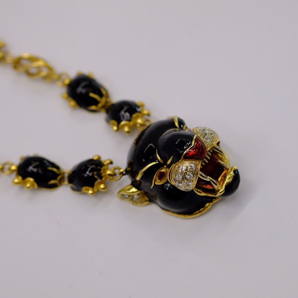 Gold, Black and Red Enamel and Diamond Panther Pendant Necklace, Frascarolo
18 kt., the roaring panther head applied with black enamel, its cheeks and ears accented by 20 white gold-set round diamonds approximately .80 ct., with red enamel nose and