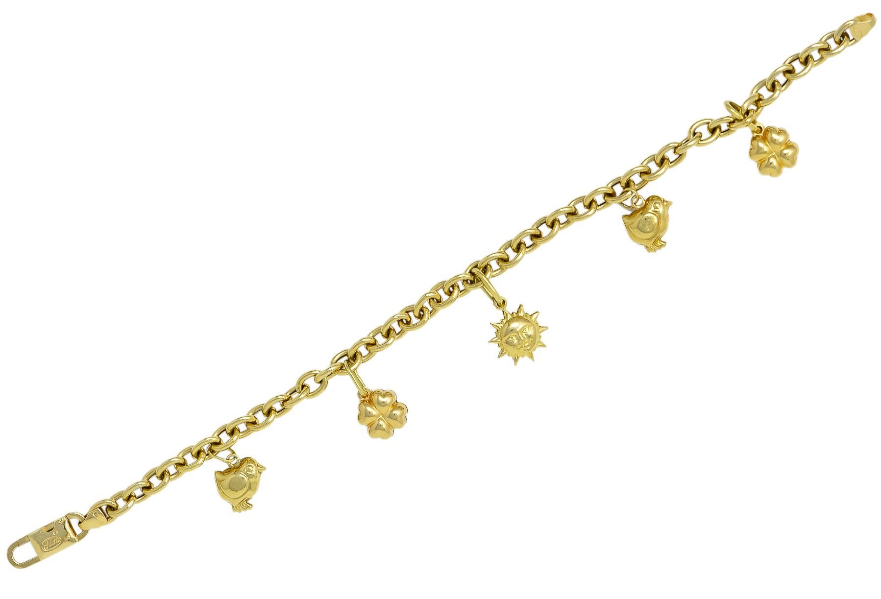 Charm bracelet designed as polished gold links

With elongated link drops featuring hollow polished gold charms of chicks, clovers, and a smiling sun

Completed by lobster clasp

Signed Chini for Fratelli Chini with Italian assay mark

Stamped 750