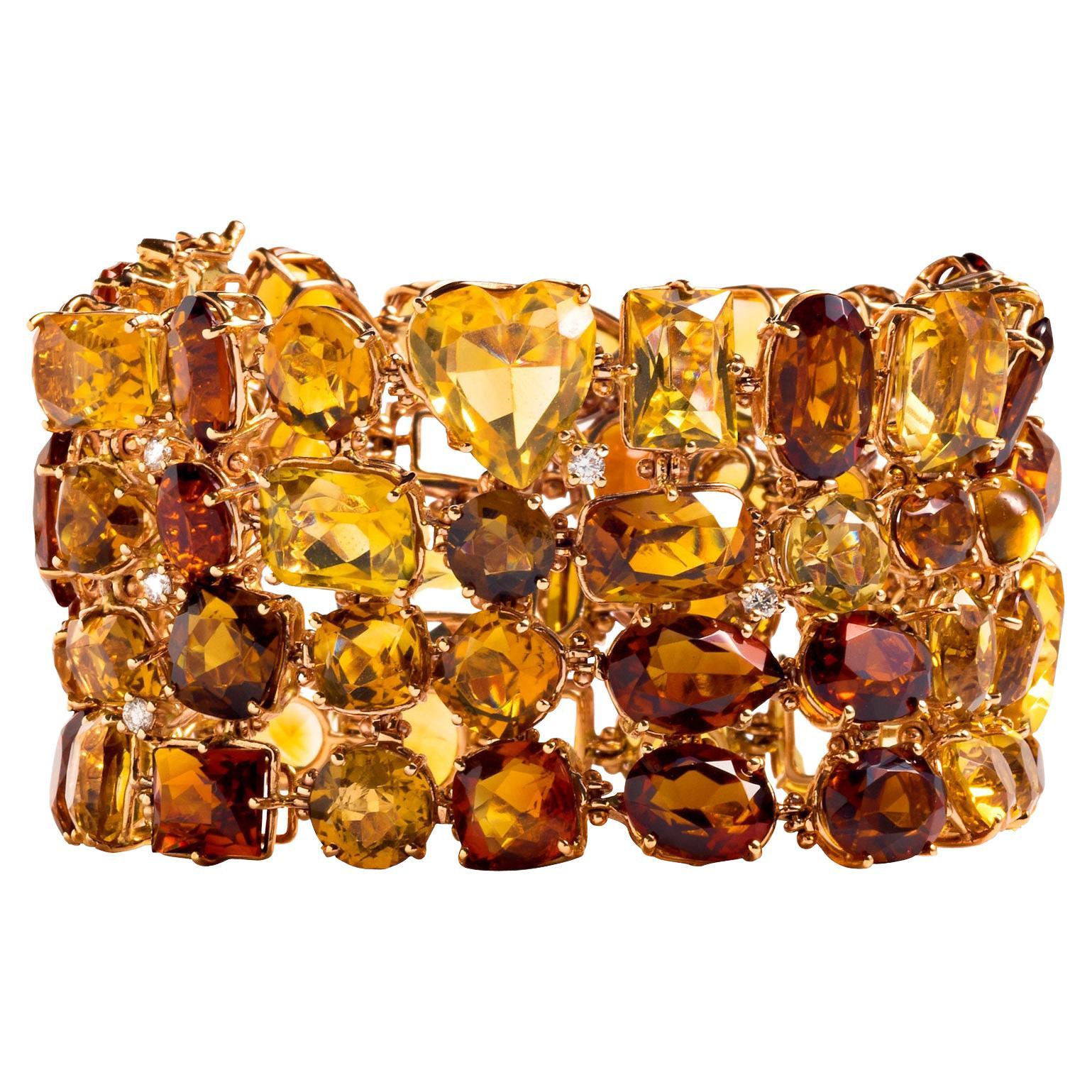 Sophisticated shades of browns and yellows envelop the wrist with this statement-making gem set bracelet. At 207 carats, this one-of-a-kind wide bracelet is laden with multi-shaped citrines, including hearts, and set in rose gold. Half a carat of