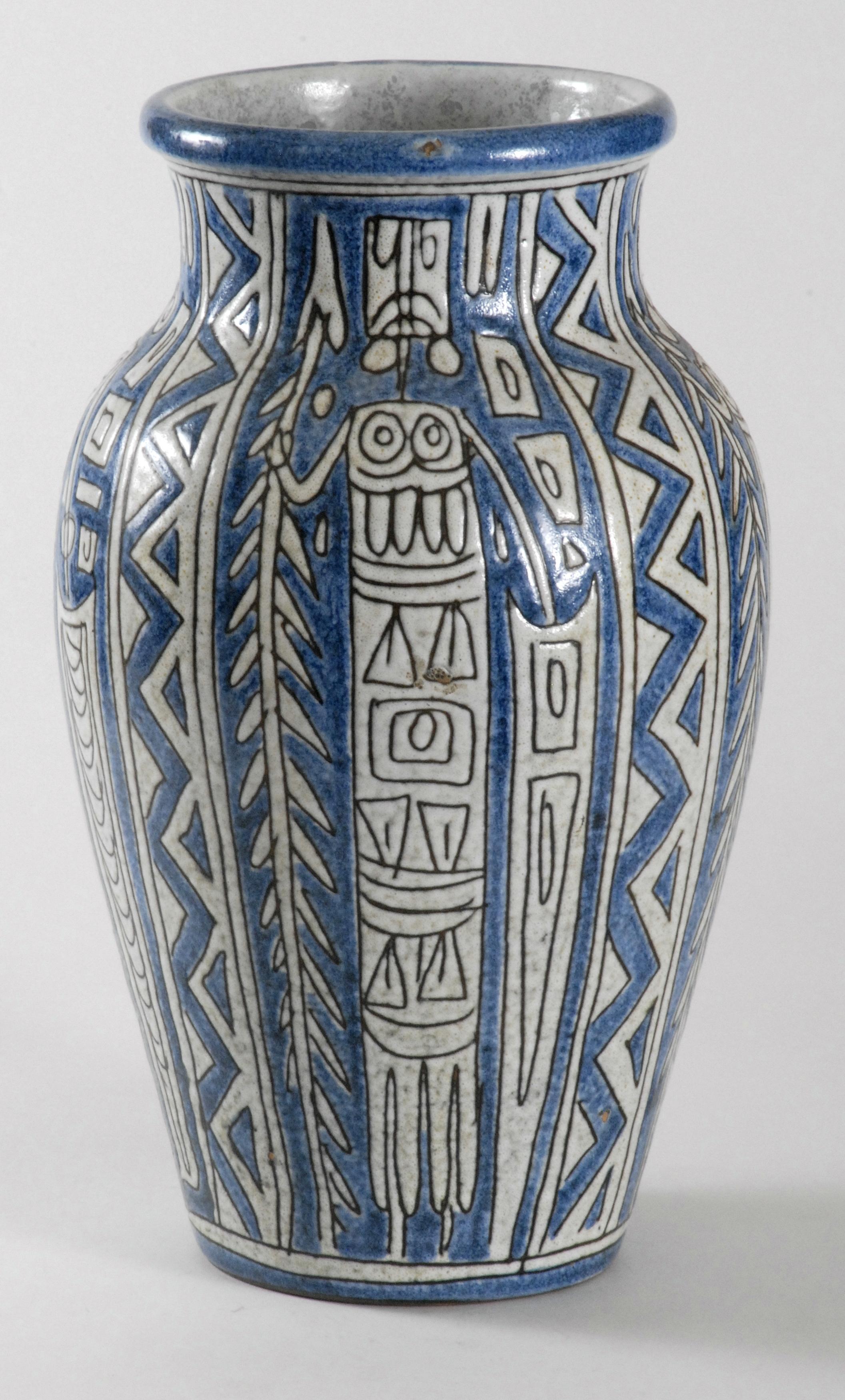 A large Fratelli vase decorated with creamy glaze 'Tribal' figures on a blue glaze background. Beautifully detailed with all the figures being different. The glaze is semi matte and very tactile.
