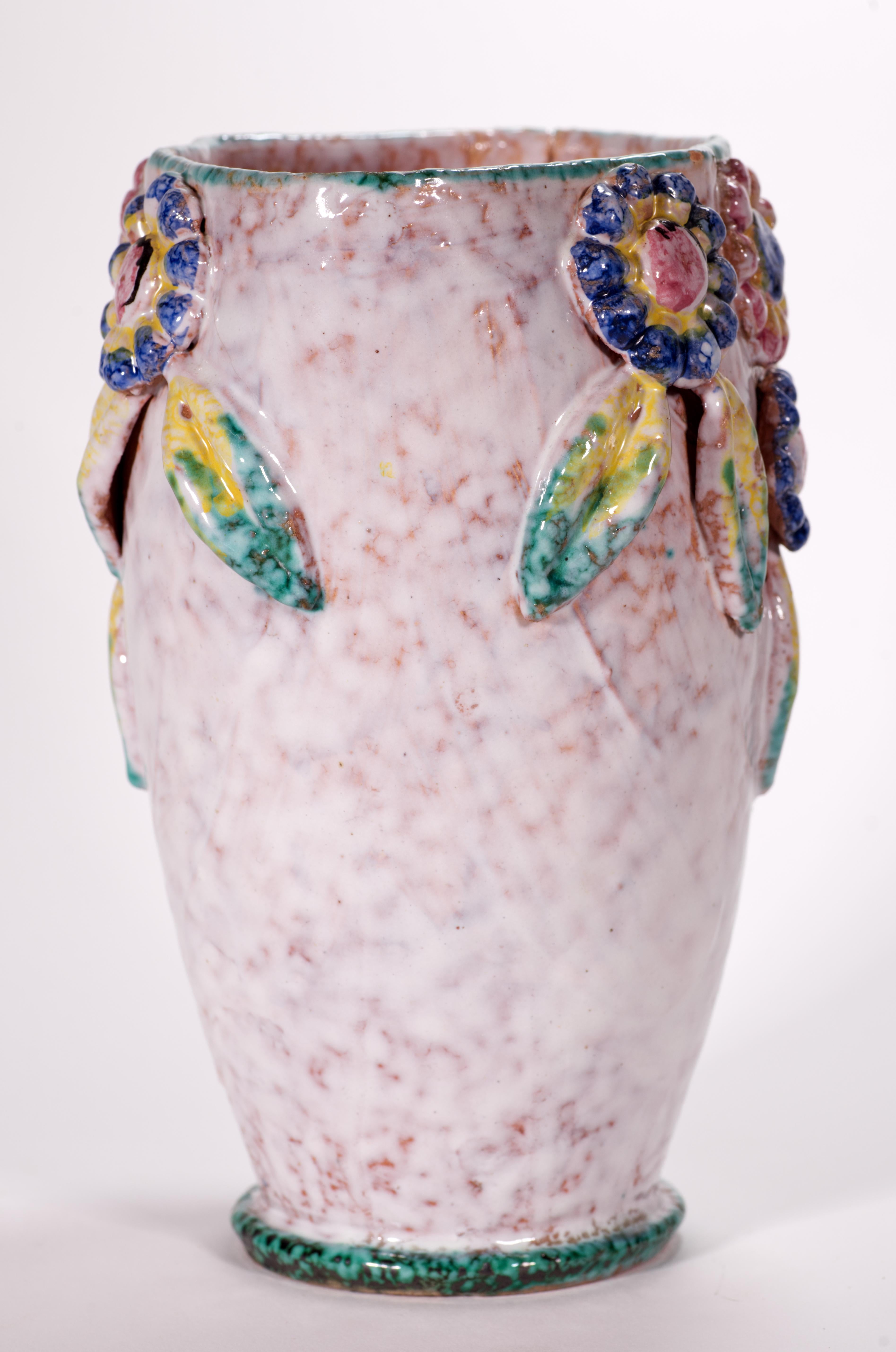  Unusual vase with complex, slightly textured glaze features applied relief in shape of abstract flowers and leaves. Top and bottom parts of the vase are decorated with delicate green rims. On inner surfaces white textured glaze on clear semi-gloss
