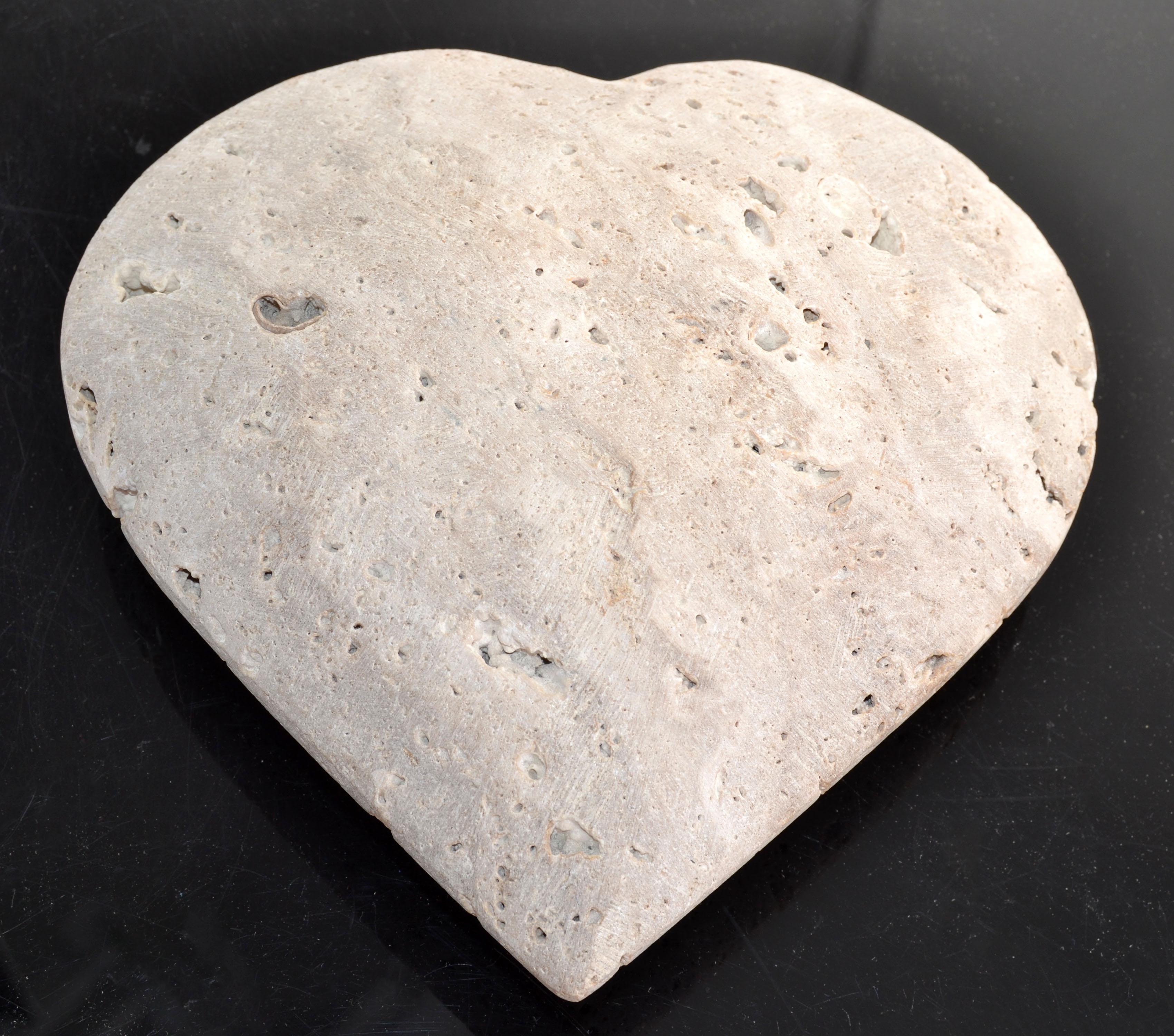The Italian Classic Riven Travertine Venice Heart Sculpture attributed to Fratelli Manelli for Raymor is a versatile element with particular design, different from any other similar design objects. 
Such a Model with special design and an elegant,