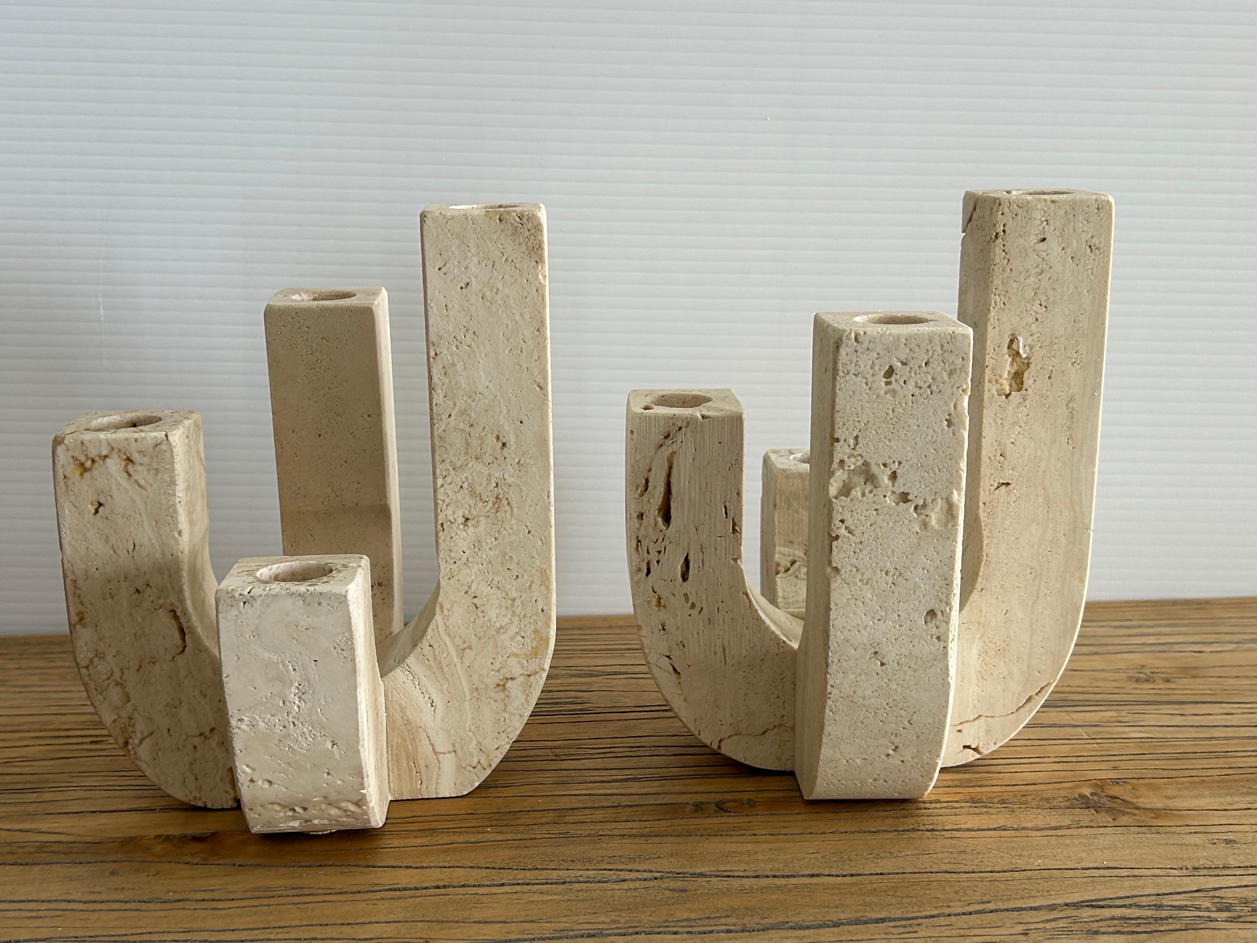 Pair of Fratelli Minelli candleholders… Travertine from the 1960s a rare find.. these elegant candleholders made of beautiful beige travertine, With  such a striking look they have beautiful negative space that presents minimalism is at its best .