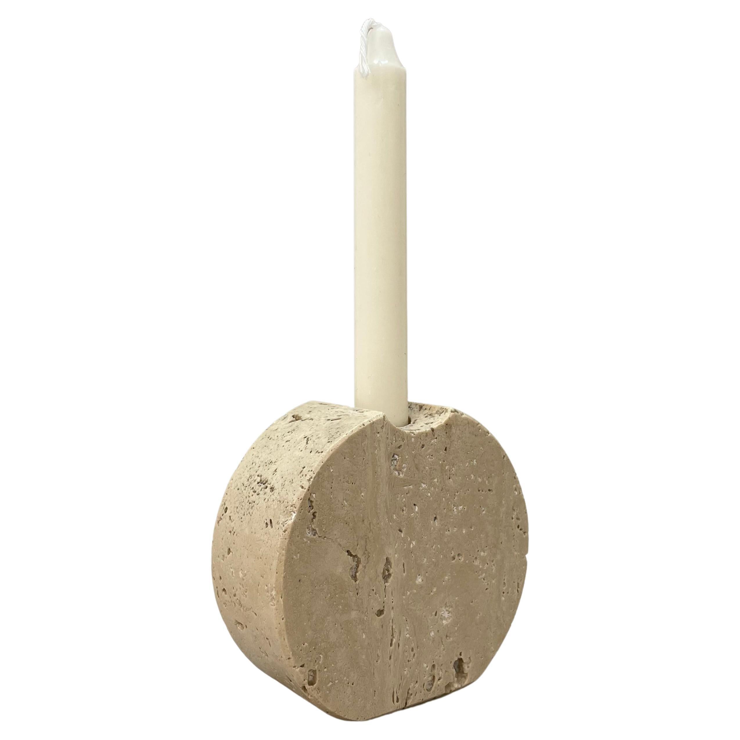 Elegant midcentury white travertine marble candleholder. This fantastic piece was designed in Italy during the 1970s by Fratelli Mannelli.

This item is perfect as the purity and the dominance of the material, white travertine marble, is finely