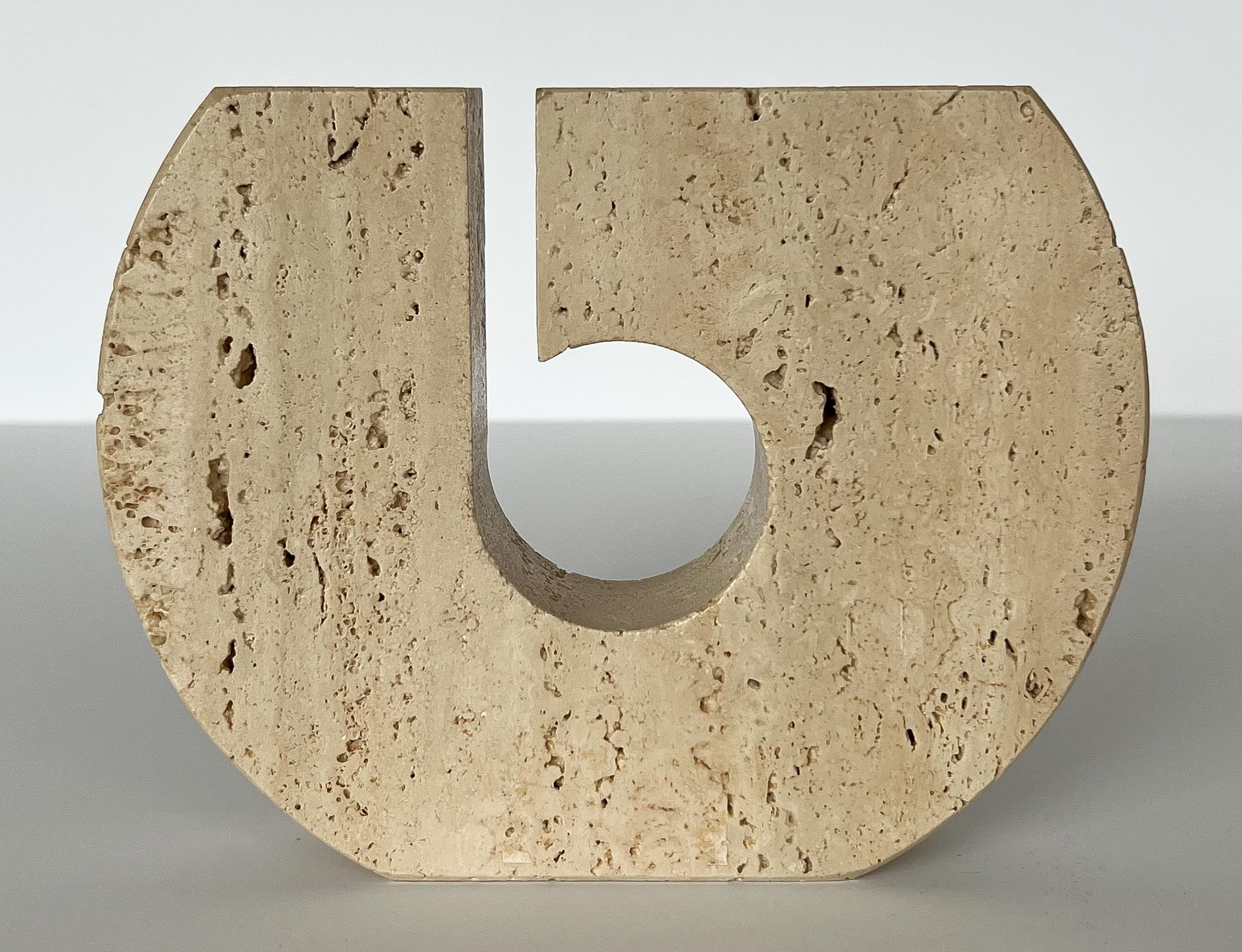 A sculptural solid Italian travertine candle holder by Fratelli Mannelli, circa 1970s. Beautiful solid unfilled travertine stone with asymmetrical cutout design. Holds three candles. Three openings each measure 3/4