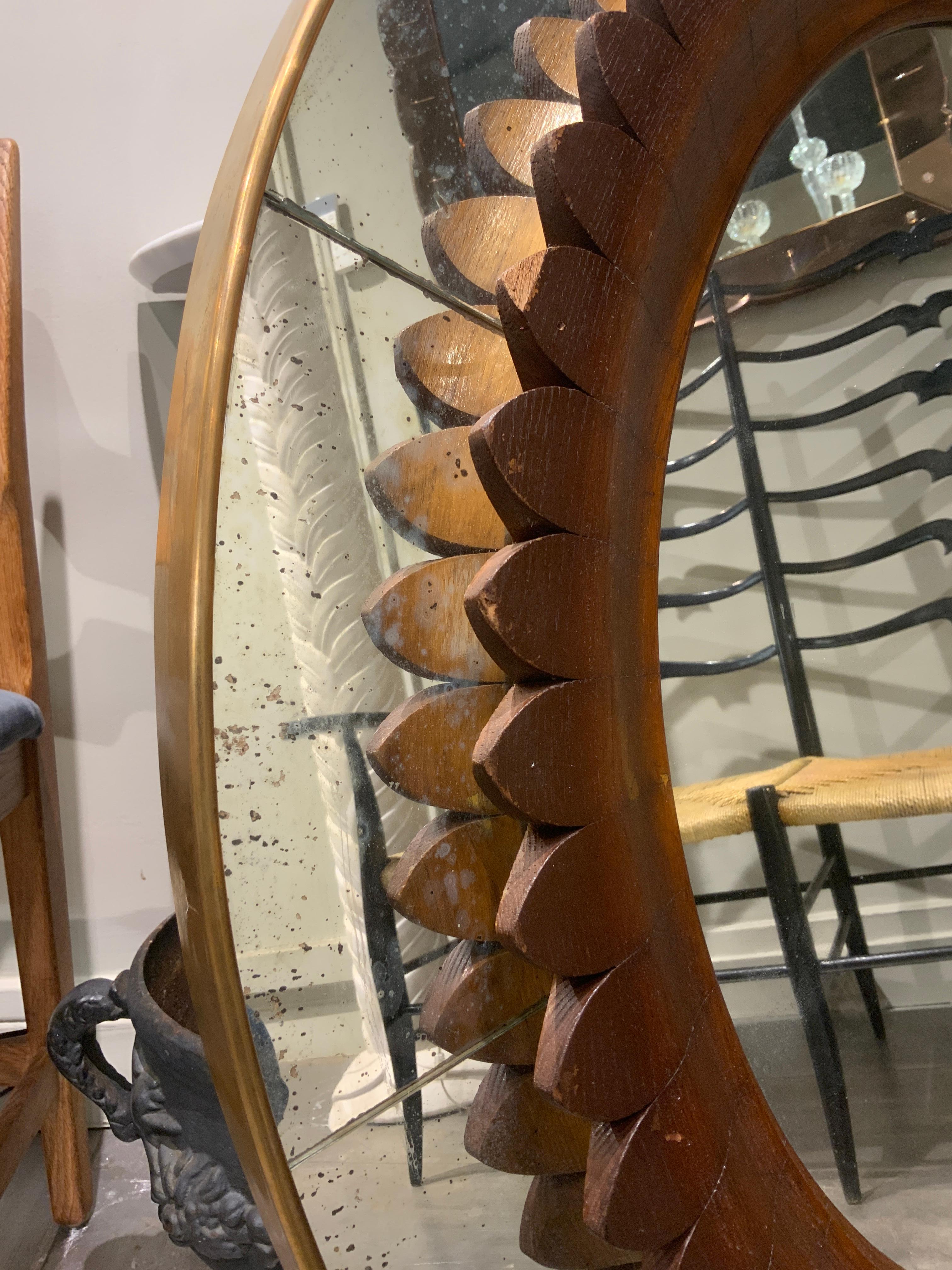 A beautiful wooden mirror with brass France by Fratelli Marelli 
Italy 1950
Patina on the mirror 
Diameter is 100 cm 