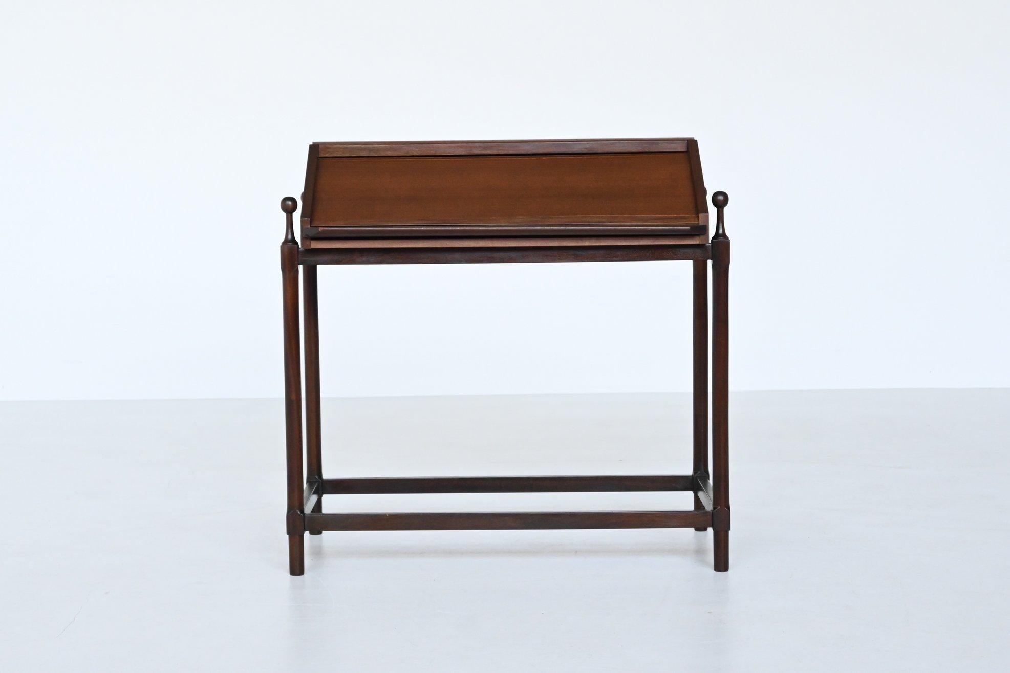 Beautiful and compact rollup writing desk designed and manufactured by Fratelli Proserpio, Italy 1960. This elegant desk is executed in rich natural teak wood. The top has a very nice trapezoidal shape and it has an unique mechanism that opens as