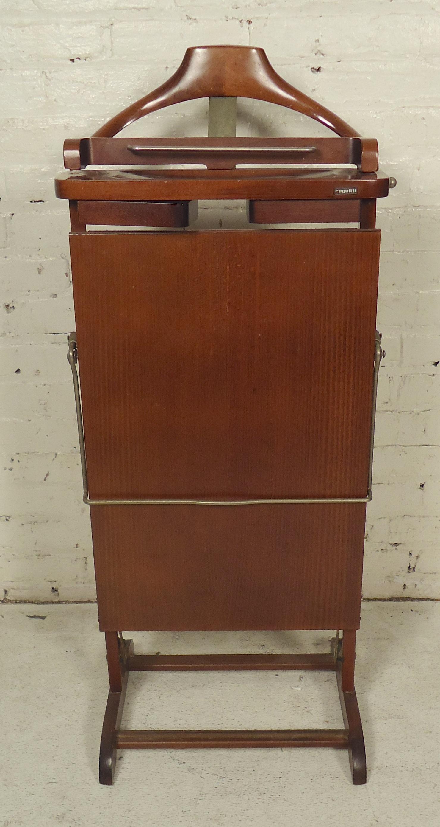 Mid-Century Modern Italian valet with plug in pant press. Also includes swing out cuff link holders.

(Please confirm item location - NY or NJ - with dealer).
     