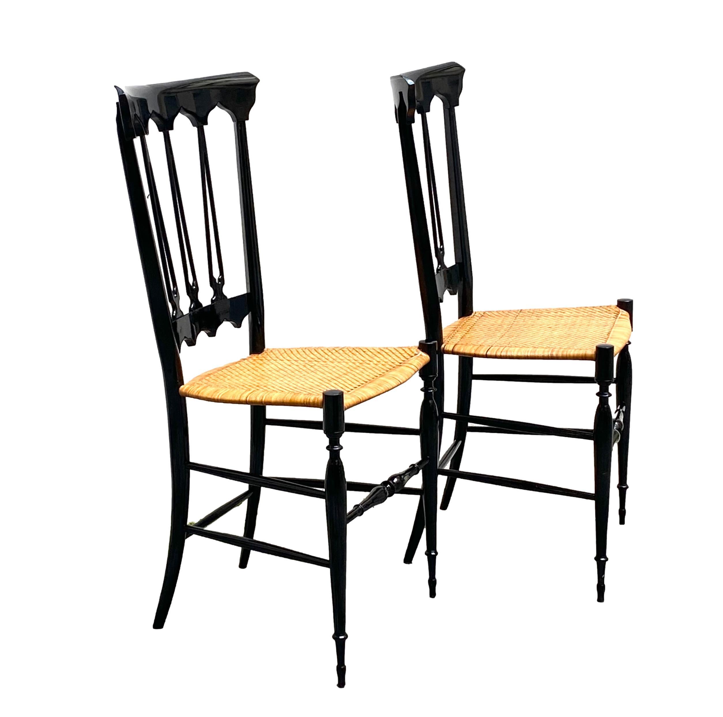Beautiful and unusual pair of dining chairs designed by Colombo Sanguineti, produced by Sedie e Mobili Sanguineti Chiavari, Italy 1950. 
Fantastic subtle and incredibly light Italian design. 
These chairs have a black lacquered wooden frame and a