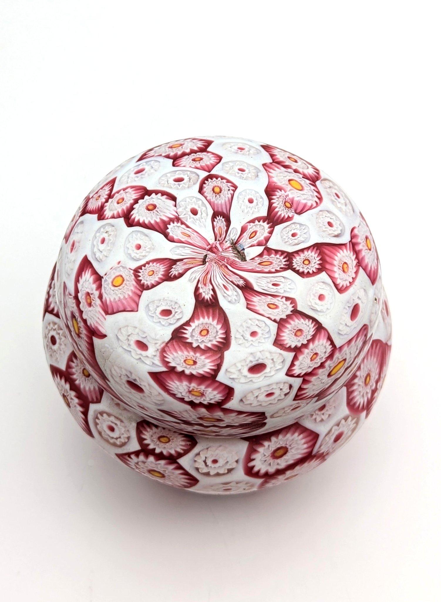 A millefiori murrine box by the Toso brothers, made on the island of Murano around 1910. The lovely colored and decorated Murrine were cut from glass canes, arranged on a plate, fused and the attached to the glass pipe for a little roll up. Both