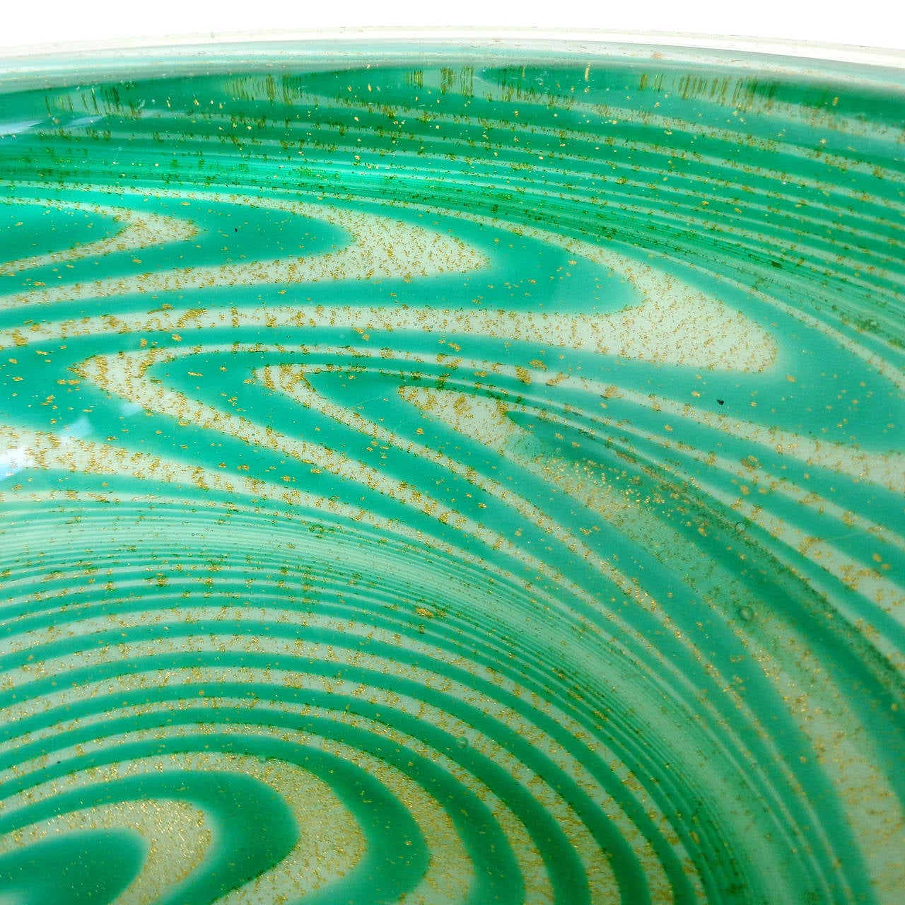 Murano hand blown green optic swirl and gold flecks Italian art glass geode bowl. Attributed to the Fratelli Toso company, for Ed Langbein, signed underneath. The Psychedelic design is very groovy. Filled with gold leaf. Measures 5 1/2
