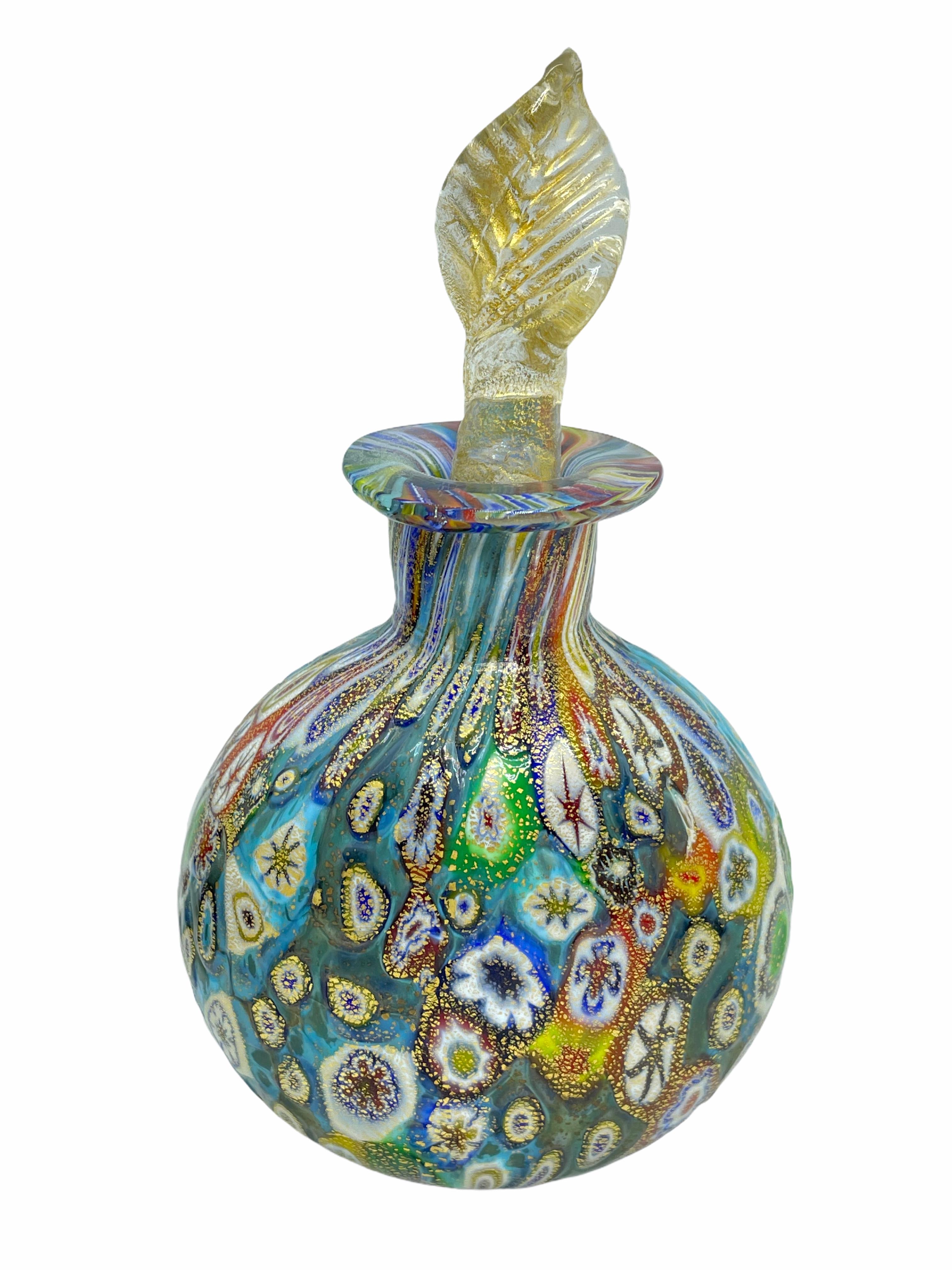 An amazing Venetian Murano glass perfume bottle, made in Italy, circa 1950s. Blue colored, with white, red, green, yellow and orange glass, topper clear with gold. No chips, cracks, or flea bites.