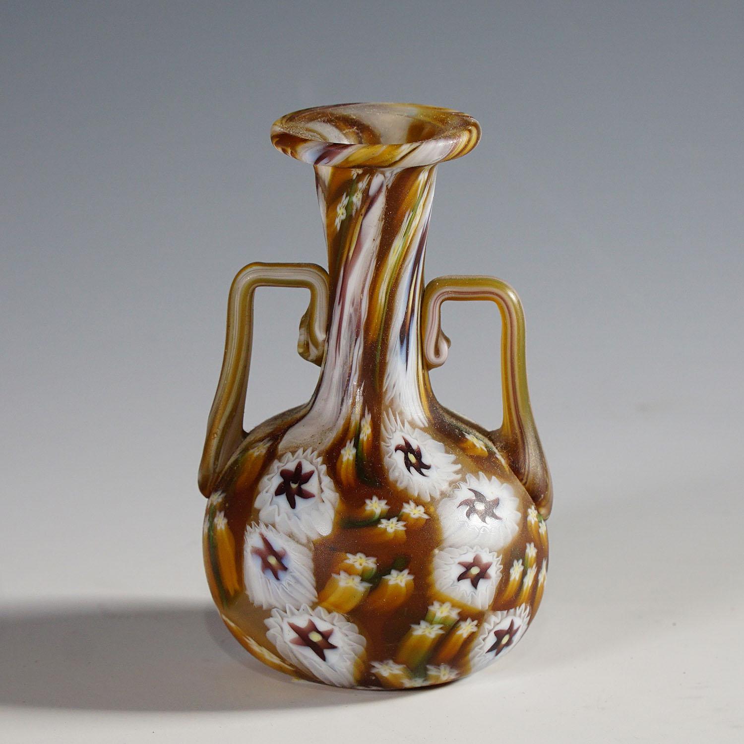 Fratelli Toso Millefiori Murrine Vase in brown and white, Murano early 20th century

An antique murrine glass vase, manufactured by Vetreria Fratelli Toso ca. 1920s. The vase is executed with polychrome stars and springflowers millefiori murrines