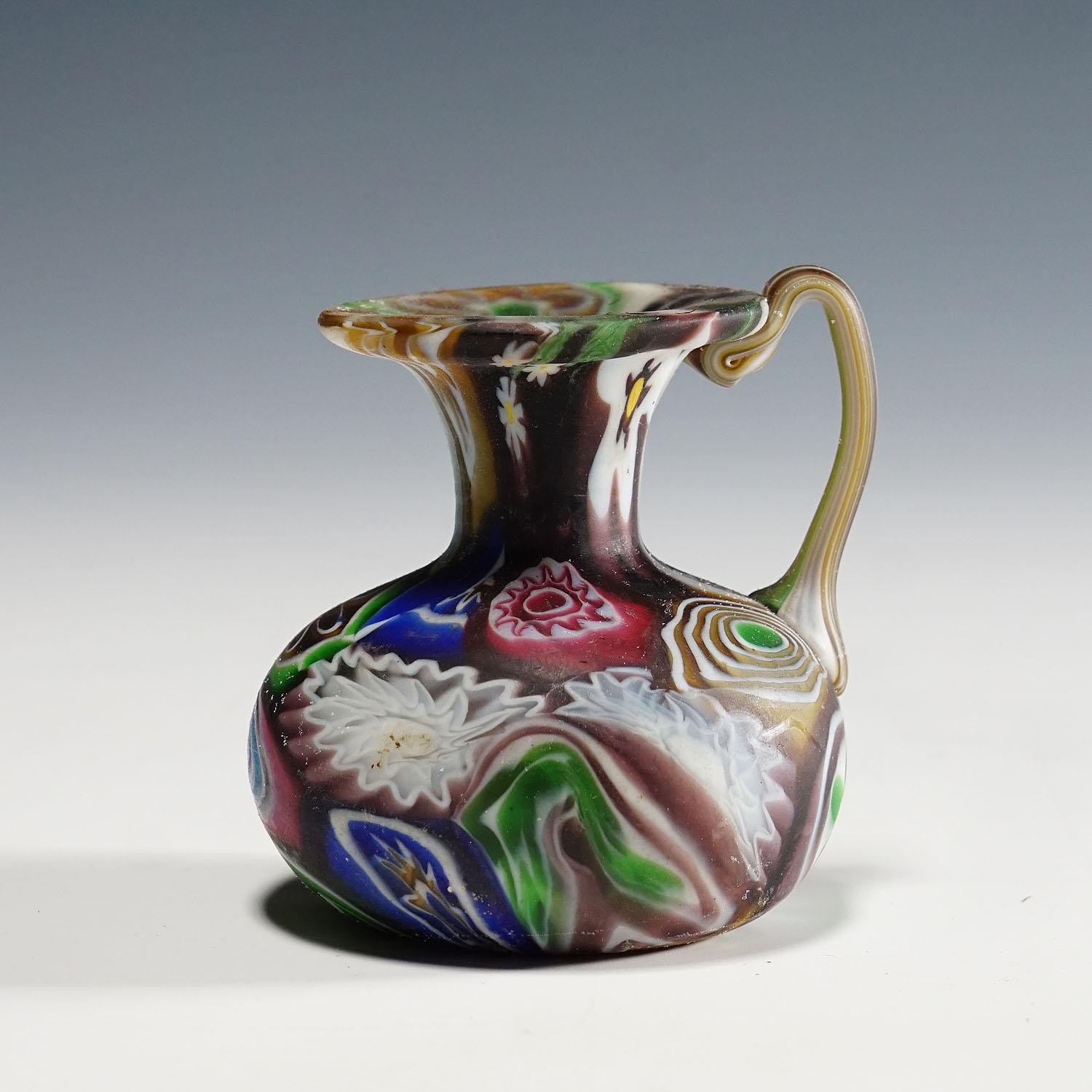 Fratelli Toso Millefiori Pitcher with Multicoloured Murrines, Murano 1910

A nice Millefiori murrine glass pitcher, manufactured by Vetreria Fratelli Toso, Murano around 1910. Manufactured with multicoloured polychrome murrines and an acid etched