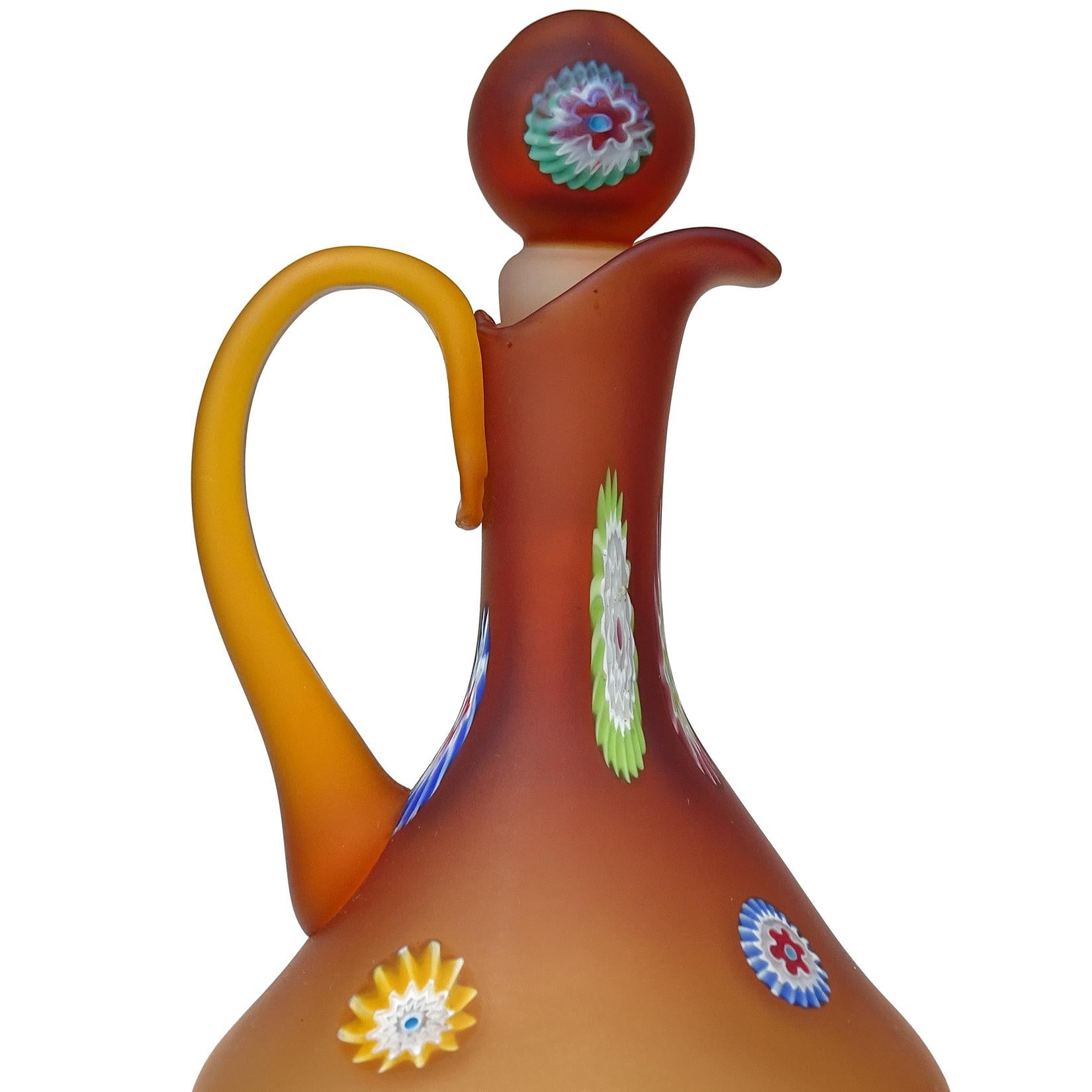 Beautiful vintage Murano hand blown amber satin surface Italian art glass ewer cruet, with applied millefiori flowers decoration. Documented to the Fratelli Toso company. It is soft to the touch. There are different flower canes throughout the