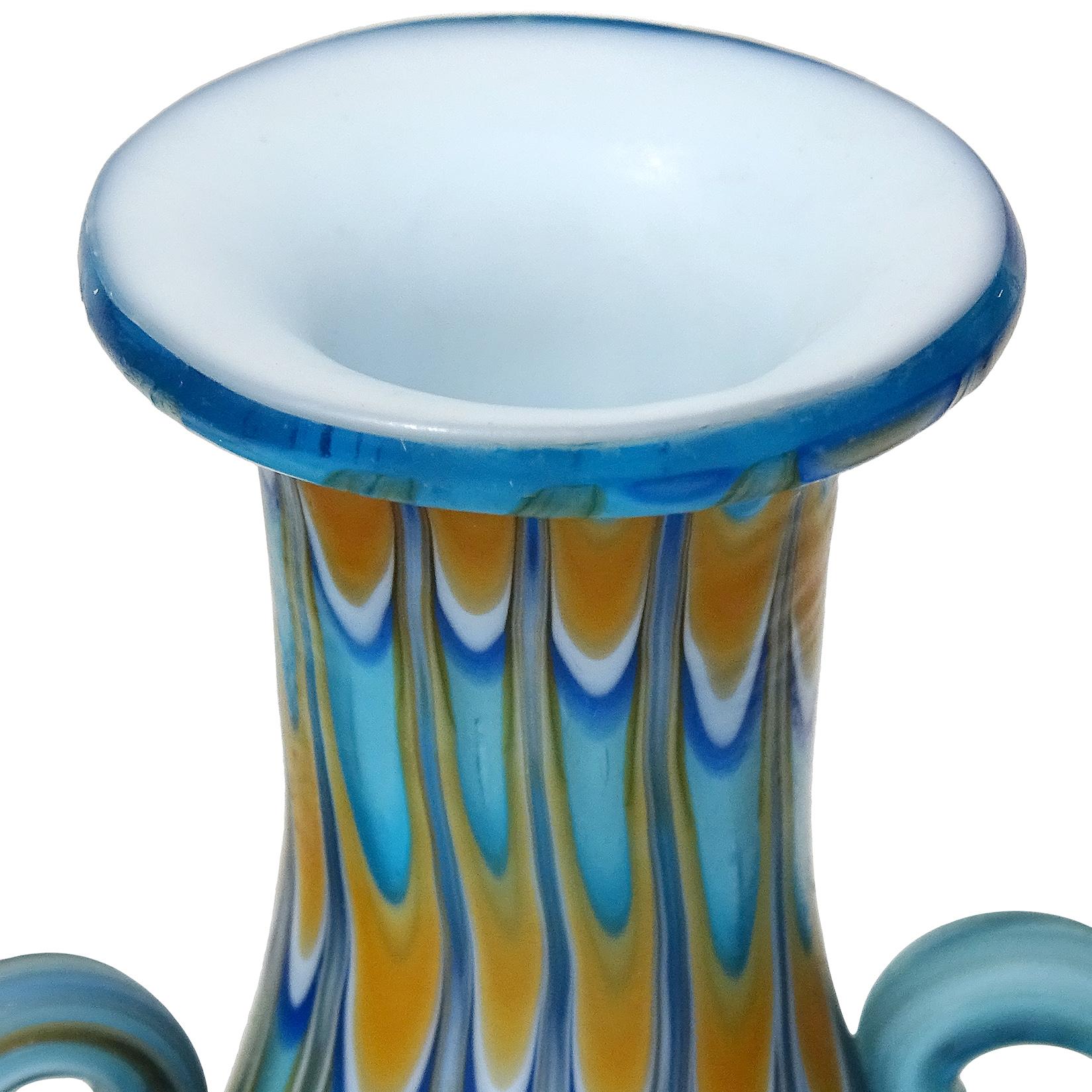 Beautiful antique Murano hand blown cobalt and sky blue, orange, and white Italian art glass decorative double handle cabinet vase. Documented to the Fratelli Toso company, circa 1900-1920. The vase has an early design and unusual color combination.
