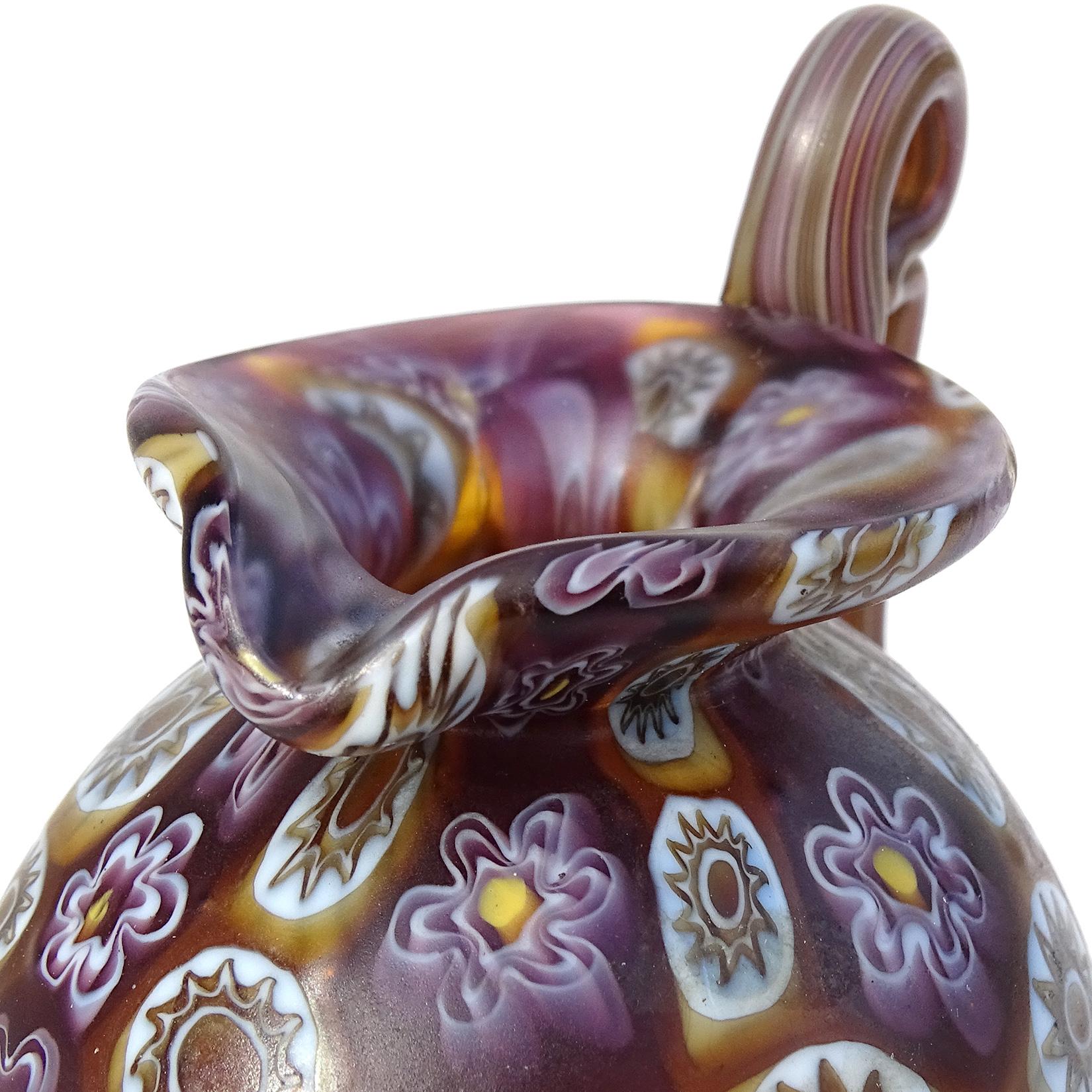 Beautiful antique Murano hand blown Millefiori Murrina flower mosaic Italian art glass decorative ornate handle cabinet vase / pitcher. Documented to the Fratelli Toso company, circa 1900-1920. The vase has an early design and color combination. The