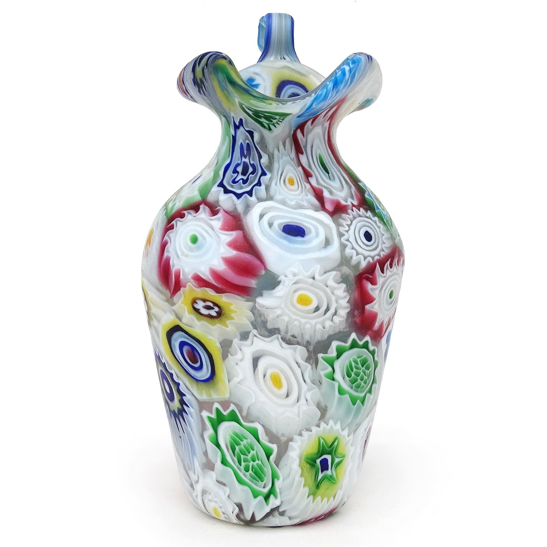 Beautiful antique Murano hand blown Millefiori Murrina flower mosaic Italian art glass decorative ornate handle cabinet vase / pitcher. Documented to the Fratelli Toso company, circa 1910-1930. The vase has an early design and unusual white