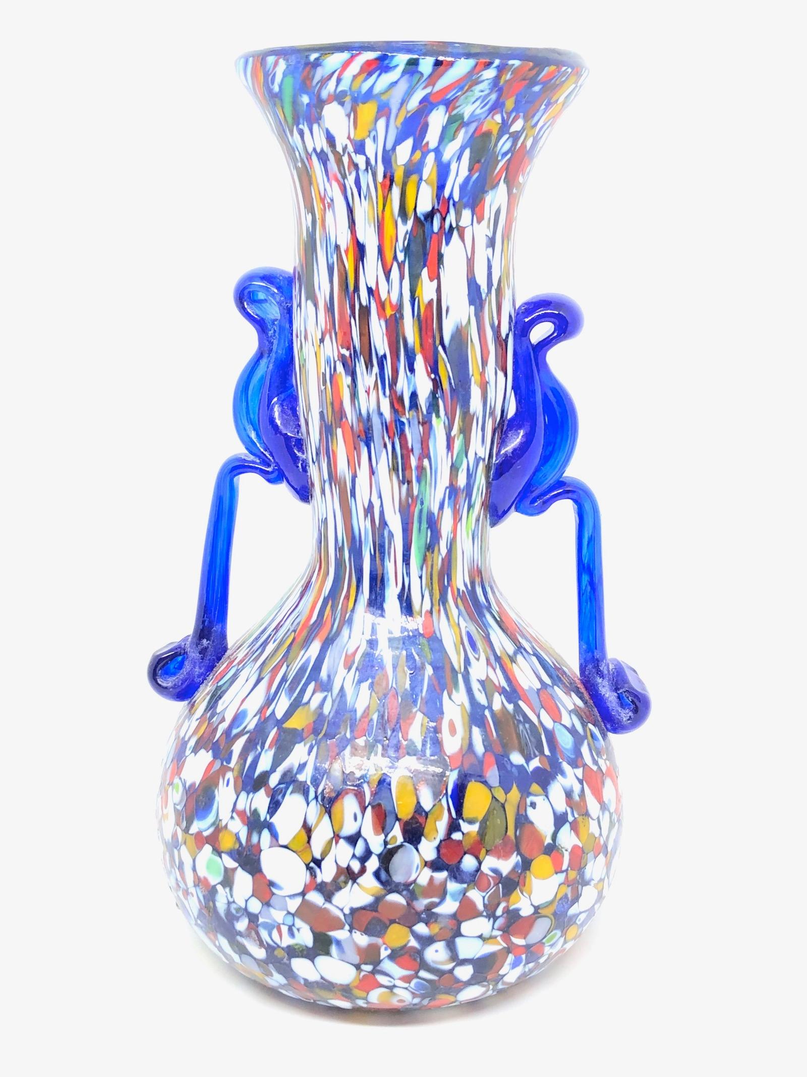 Beautiful Murano hand blown Italian art glass vase. Created by a Fratelli Toso company. Blue core with colourful murine and blue applied handles. A beautiful piece of art for any room.