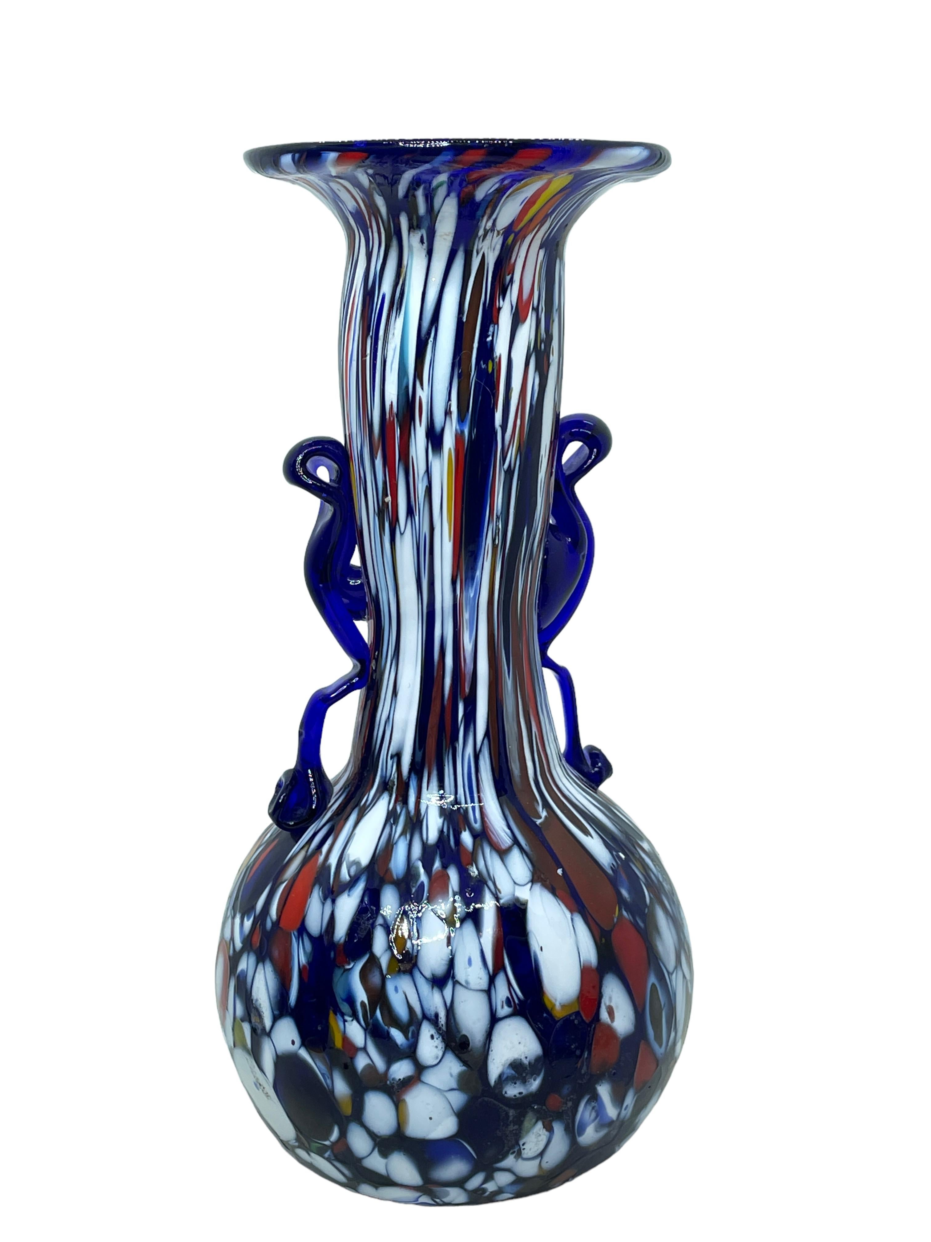 Beautiful Murano hand blown Italian art glass vase. Created by a Fratelli Toso company. Blue core with colourful murine and blue applied handles. A beautiful piece of art for any room.