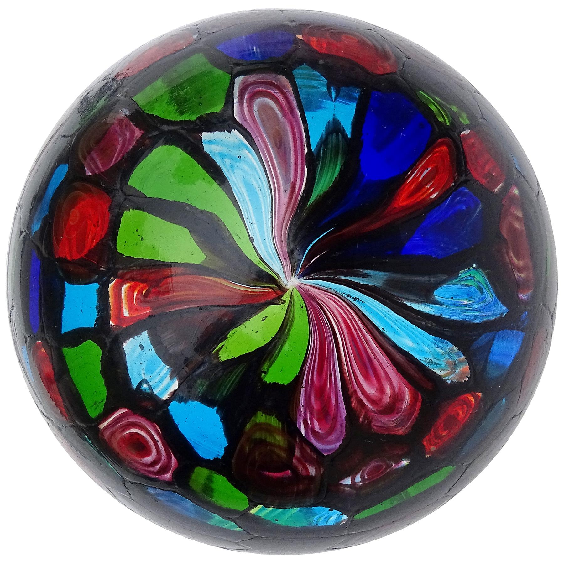 Beautiful, vintage Murano hand blown multi-color murrine with black Italian art glass mosaic paperweight. Documented to the Fratelli Toso company. The murrines pieces are all lined in black, like stained glass windows. It has cobalt blue, light