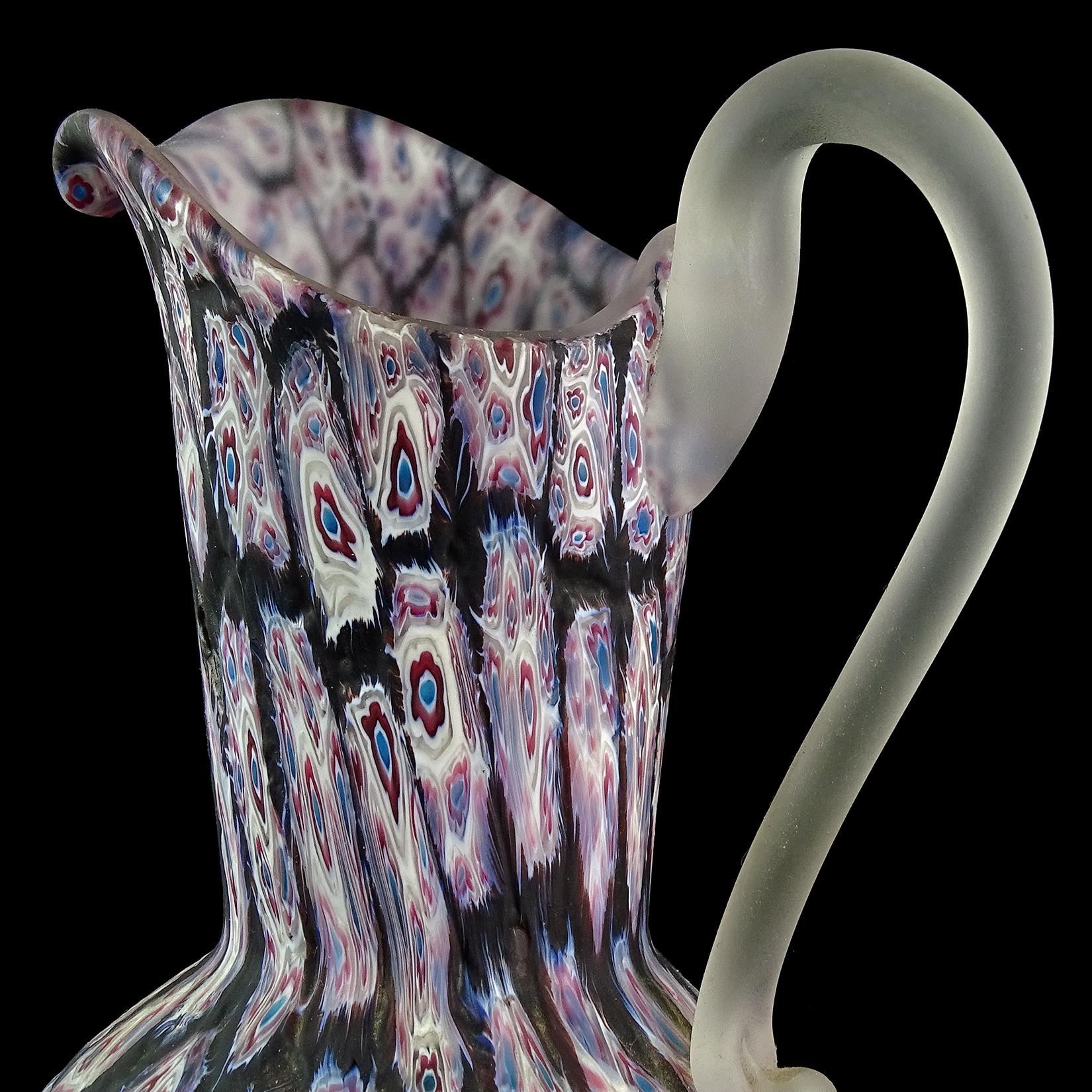 Beautiful and unusual Murano hand blown white, blue, red-purple Millefiori flower mosaic Italian art glass pitcher / vase. Documented to designer Ermanno Toso, for Fratelli Toso circa 1960s. The design is a version of 