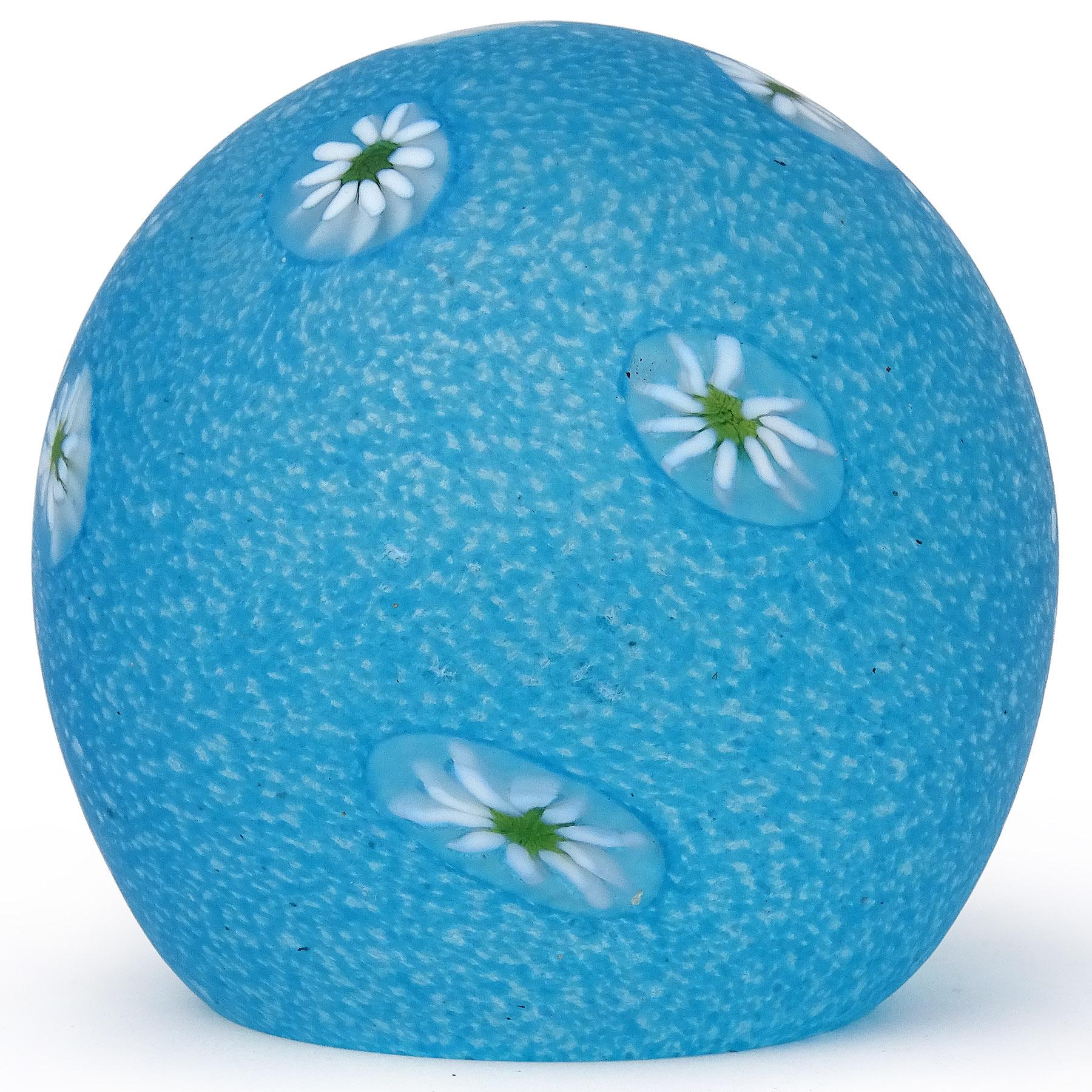 Beautiful vintage Murano hand blown light sky blue mini spots and white daisy millefiori flower murrines Italian art glass paperweight. Documented to the Fratelli Toso company. Created with a satin surface. The inside is clear glass. Would make a