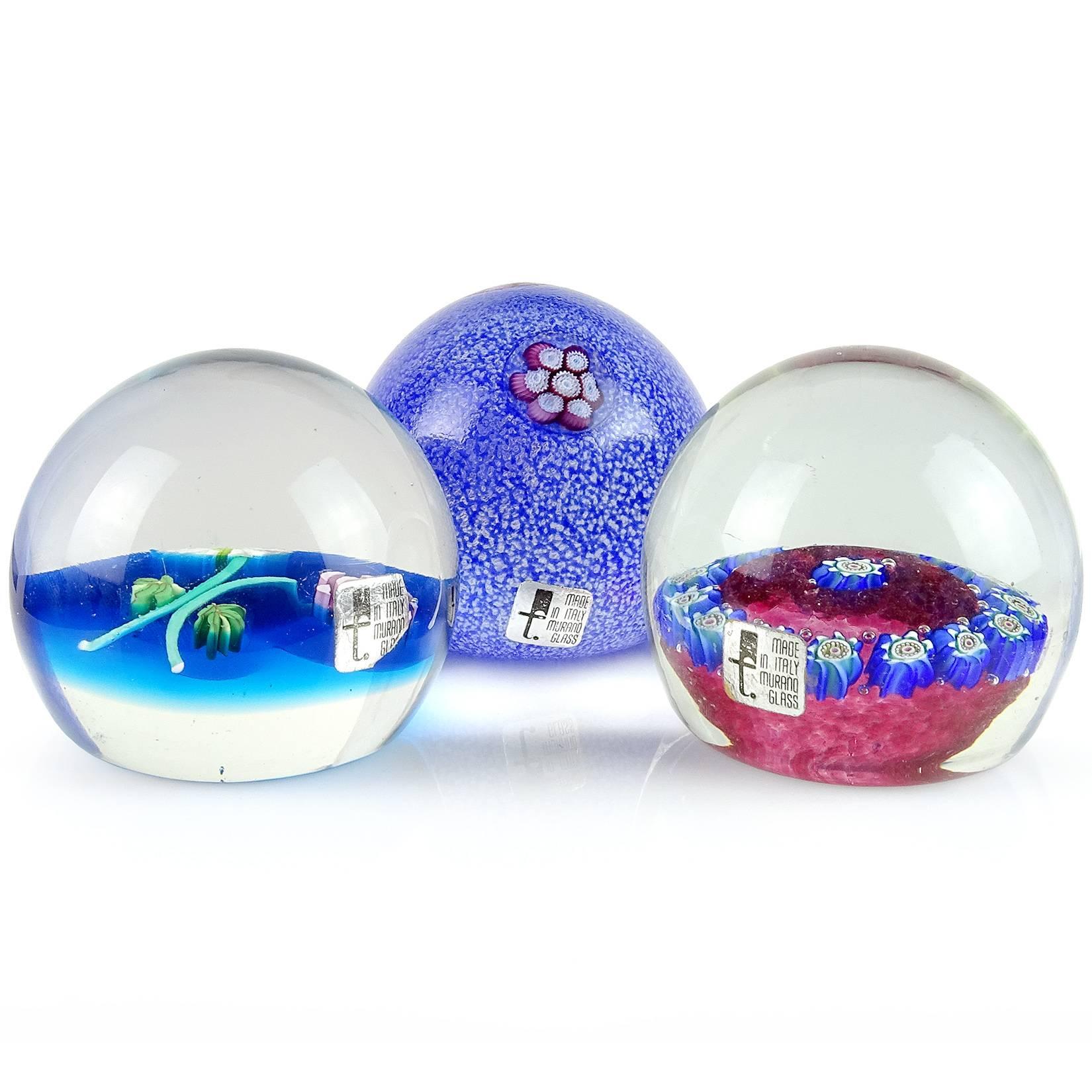 Priced per item (3 designs available). Beautiful vintage Murano hand blown flower design Italian art glass paperweights. Documented to the Fratelli Toso Company, all with original labels. Top paperweight has a melted overshot surface with purple and