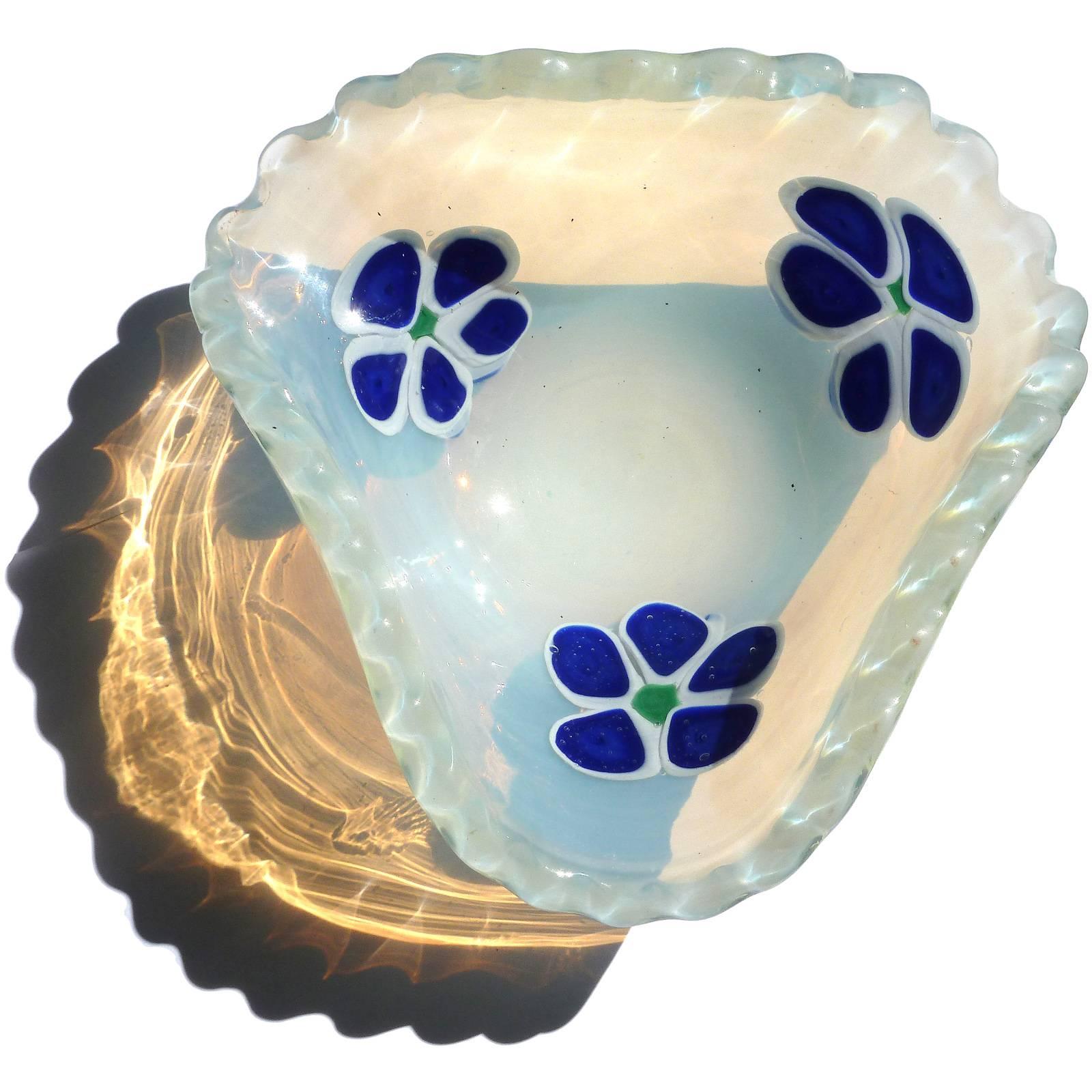 Beautiful vintage Murano hand blown fiery opalescent and blue flowers Italian art glass bowl. Documented to the Fratelli Toso company. It has a scalloped rim with three large cobalt blue flowers, lined in white. They are made of bulls-eye murrines.