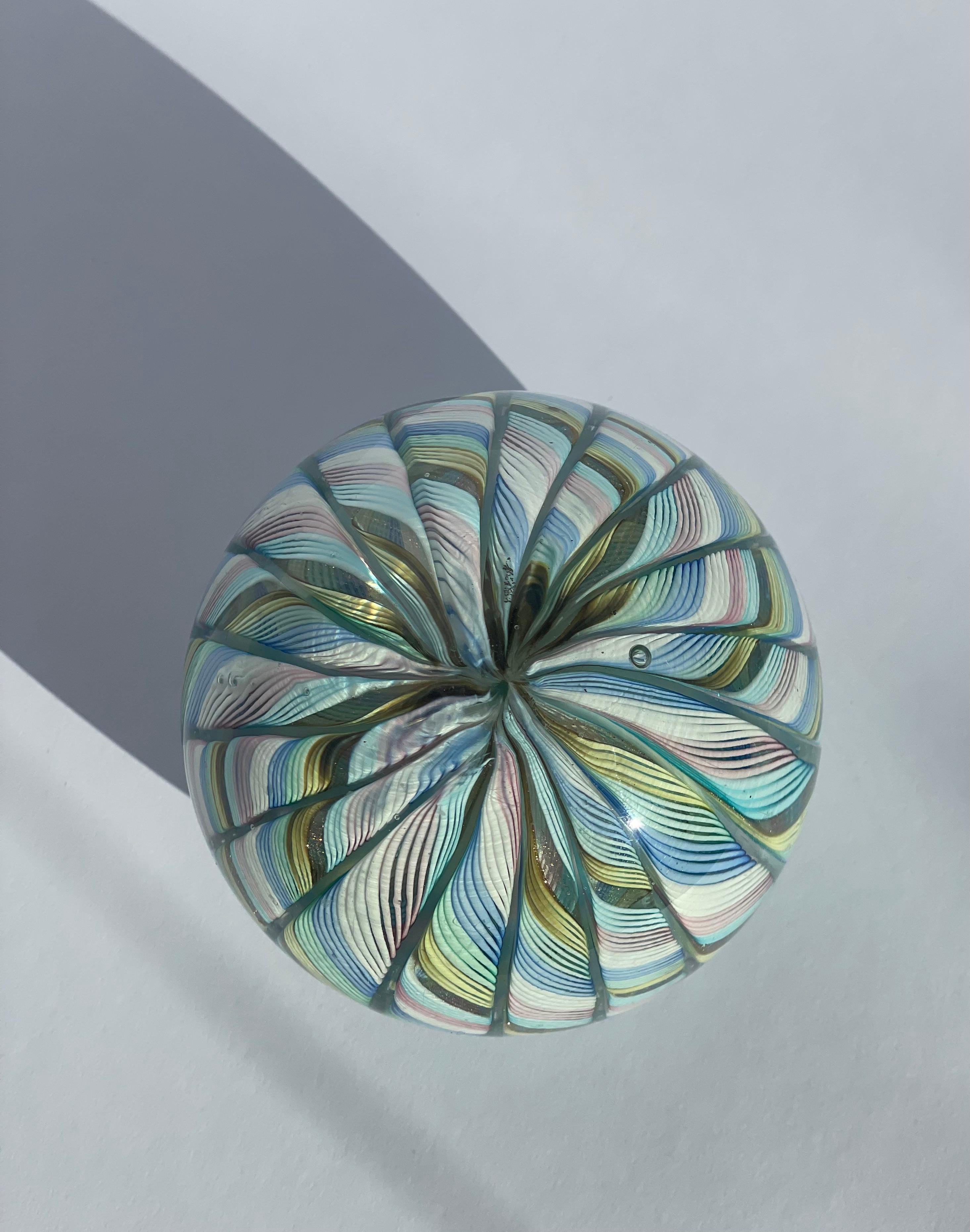 This Fratelli Toso Murano glass Latticino paperweight is a true burst of color and sparkle, crafted in Italy in the 1950s. A kaleidoscope of blue, yellow, green, pink750 and white, this paperweight doesn’t just hold papers – it holds attention! The