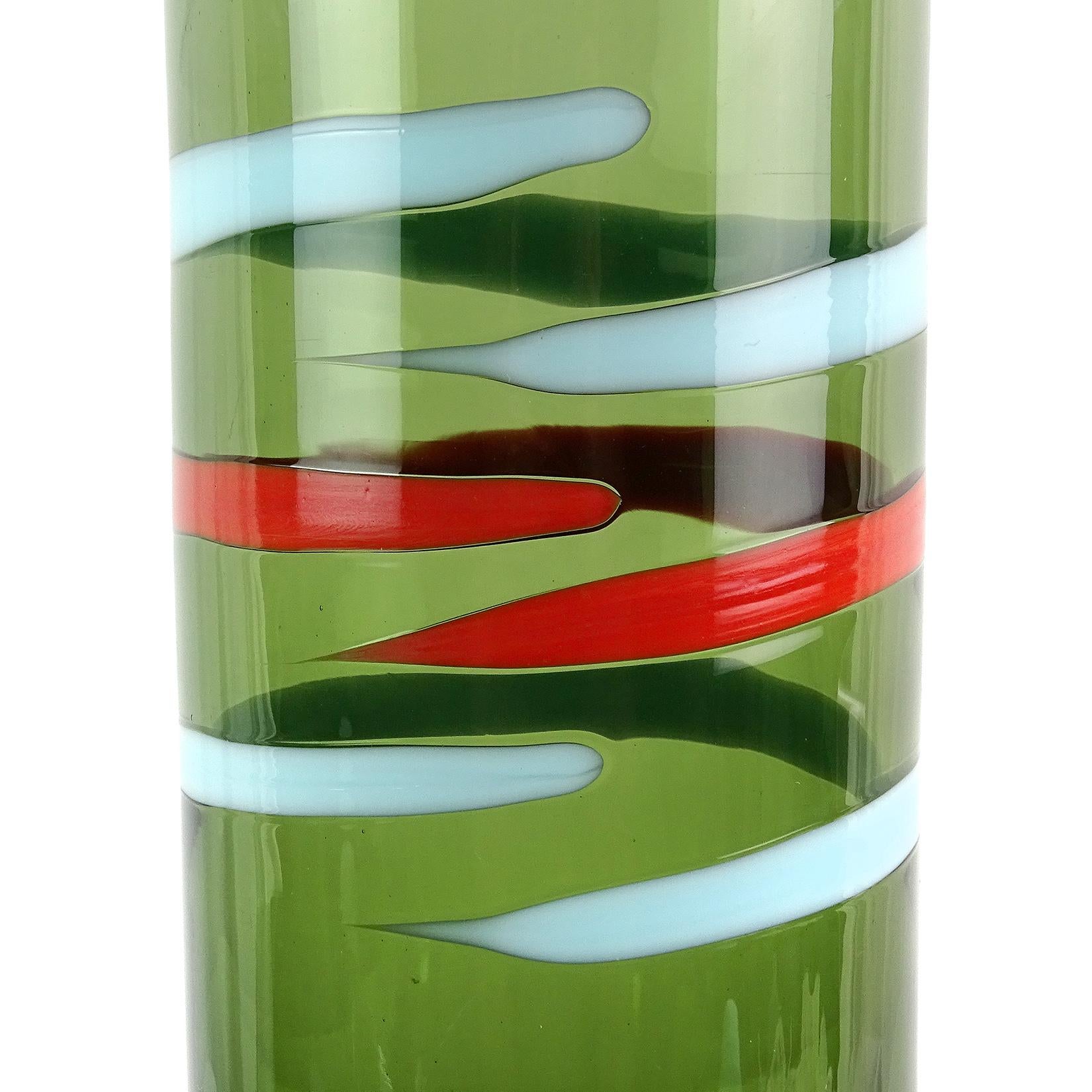 Beautiful vintage Murano hand blown green body, with red and blue stripes Italian art glass decanter. Documented to the Fratelli Toso Company. Retains its original ball stopper, matching the blue in the stripe. Great graphic design and color