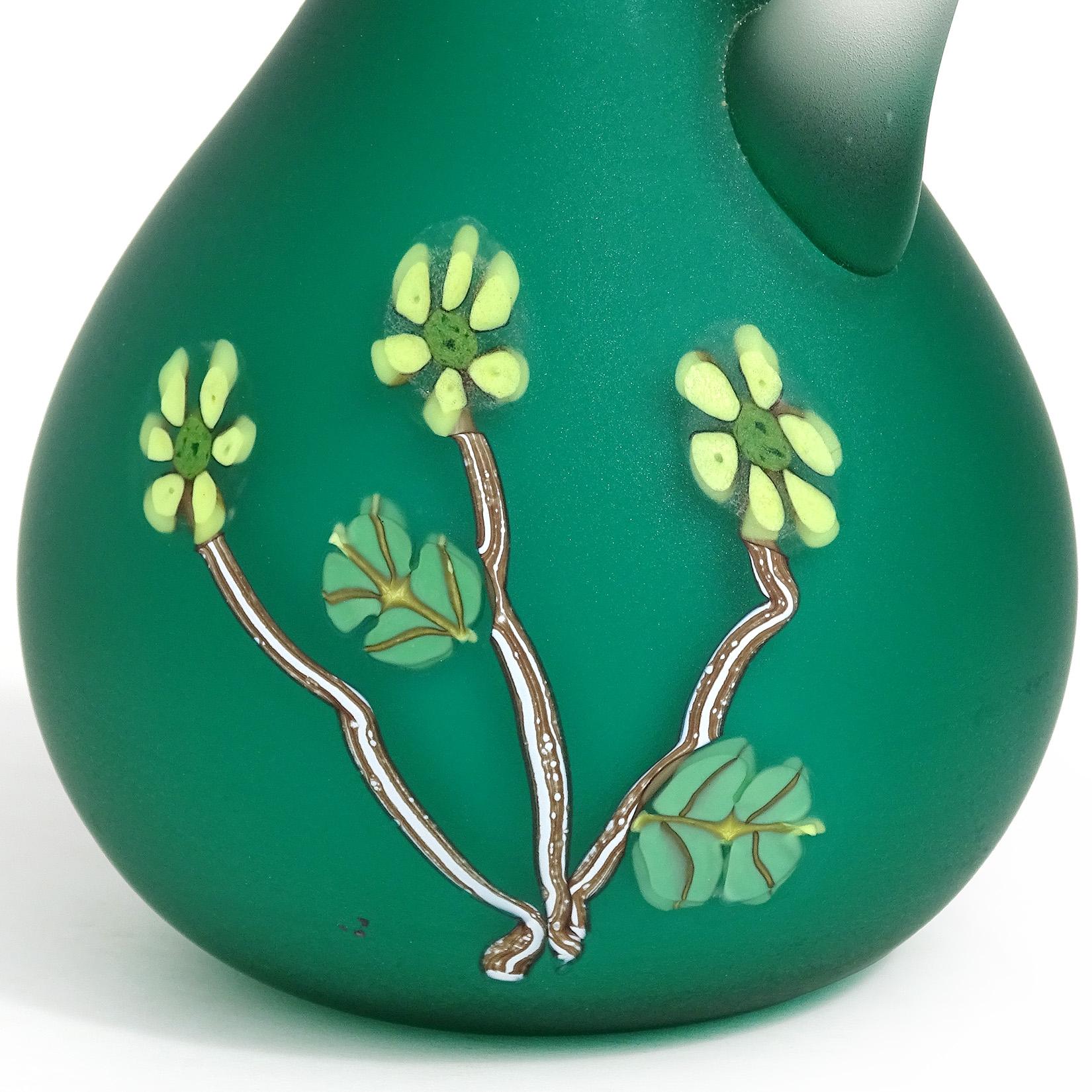 Beautiful vintage Murano hand blown green satin surface Italian art glass ewer cruet, with applied millefiori flowers decoration. Documented to the Fratelli Toso company. It is soft to the touch like velvet. The surface has yellow flowers and leafs