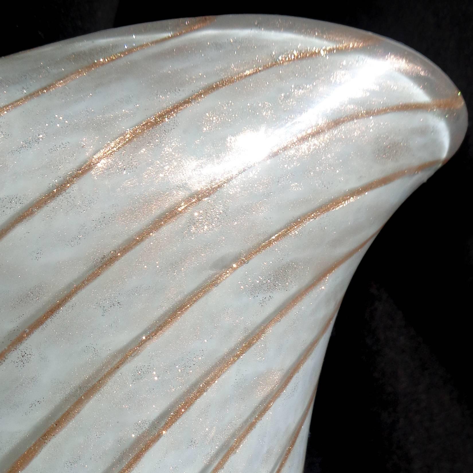 Beautiful Murano hand blown light blue (almost gray) over white, and copper aventurine Italian art glass flower vase. Documented to the Fratelli Toso Company. The piece has a candy cane swirl and glitters in the light. Original worn label still