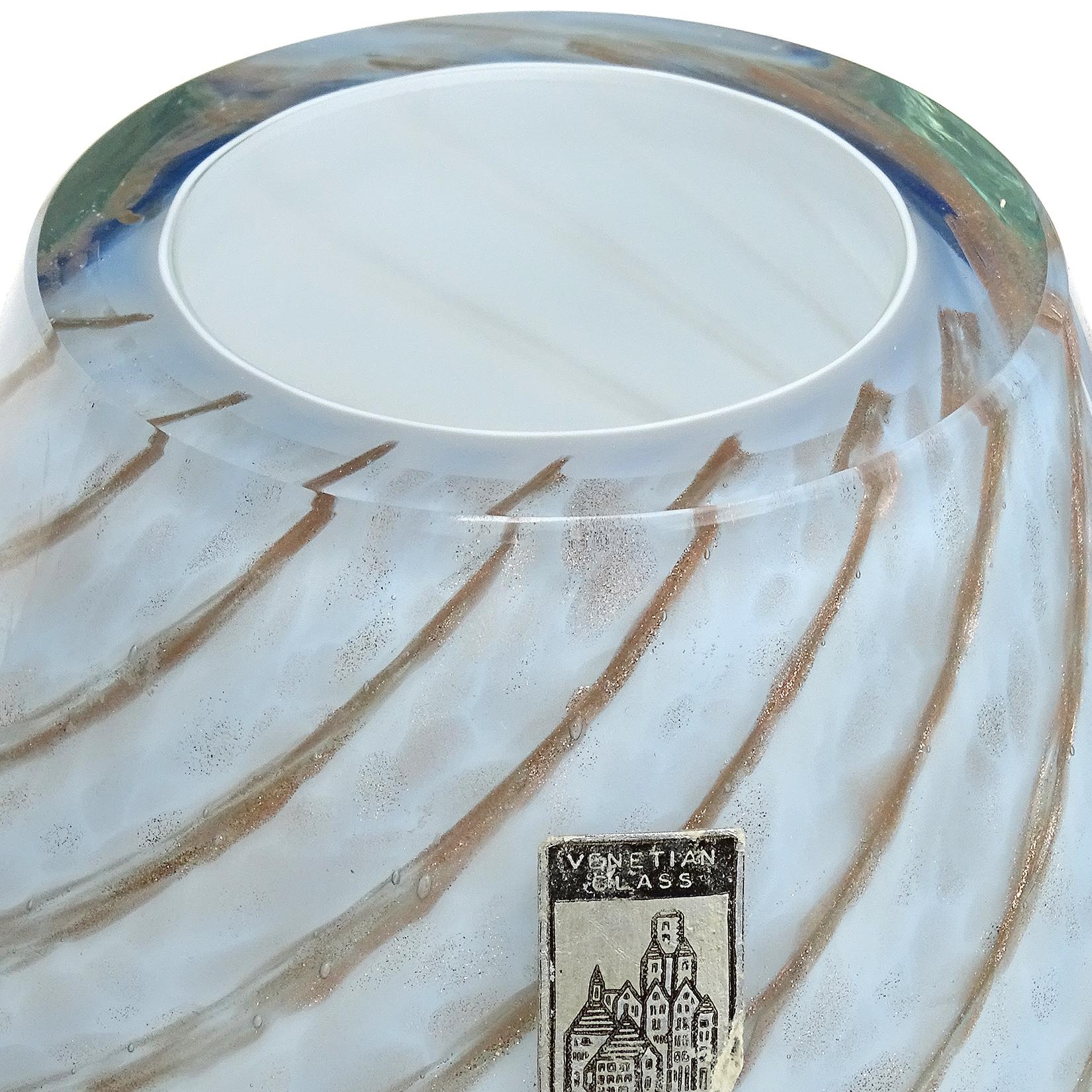 Beautiful vintage Murano hand blown light blue over white, and copper aventurine Italian art glass flower vase. Documented to the Fratelli Toso company. Published. The piece has a candy cane swirl and glitters in the light. Can be used as a display