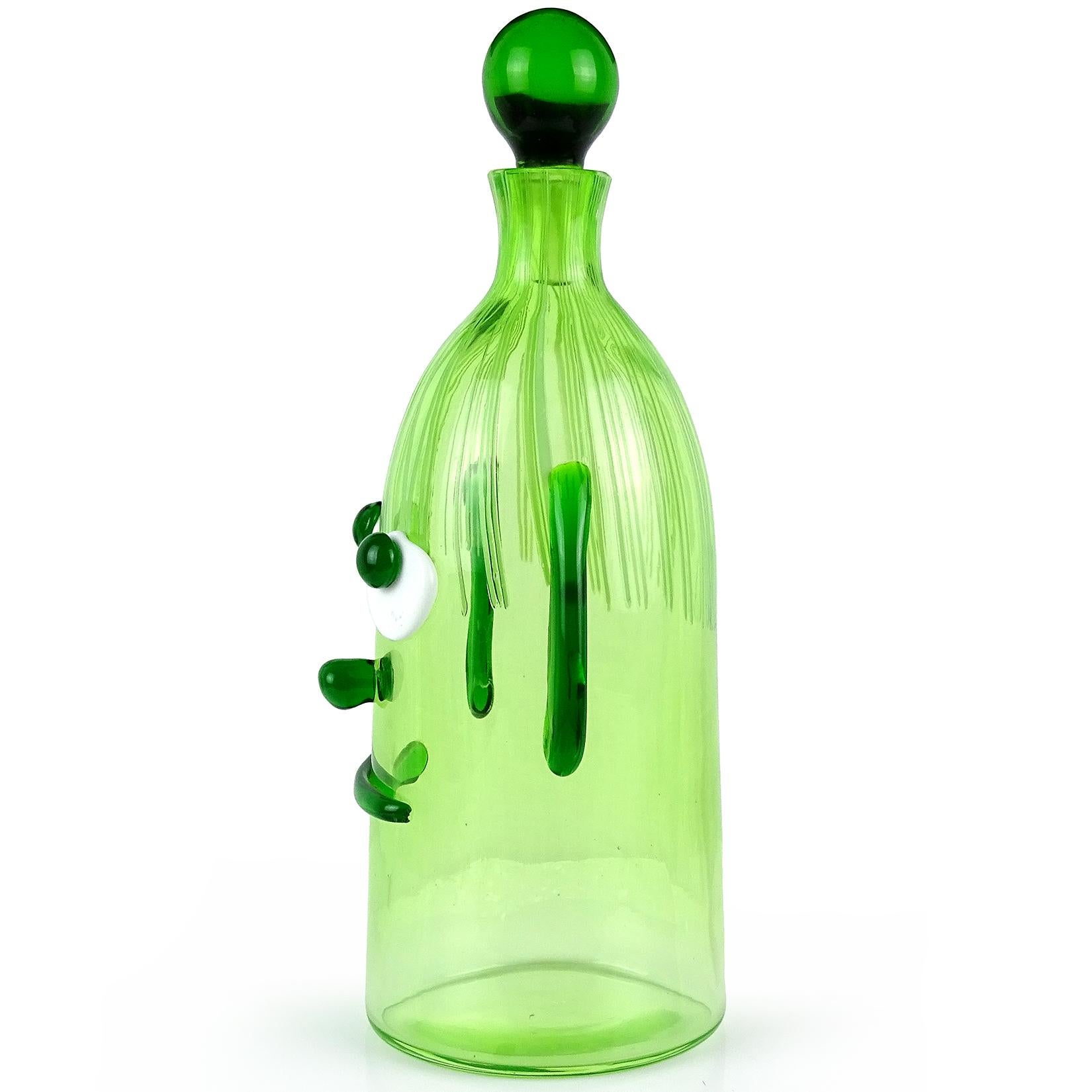 Cute and unusual Murano hand blown Italian art glass decanter, with green and white clown face. Documented to the Fratelli Toso Company. The piece has applied ears, wide eyes, a big smile and threads of pink glass for the hair. Measures: 11