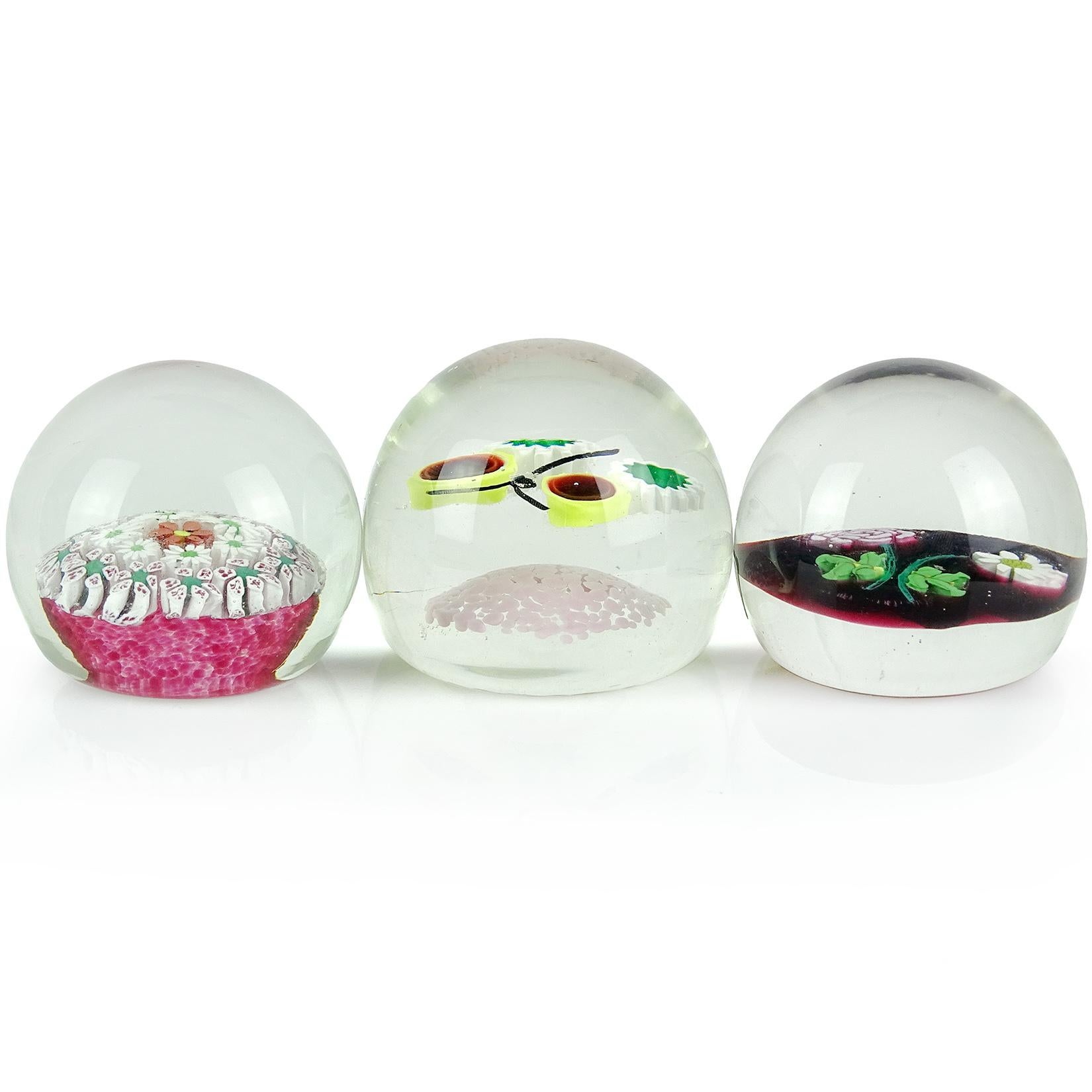 Priced individually (3 designs available as shown). Beautiful vintage Murano hand blown Italian art glass paperweights. Documented to the Fratelli Toso Company. The first has concentric rows of wild flowers on a magenta pink dots base. The second is