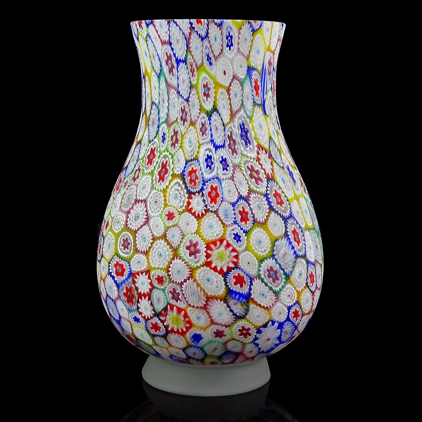 Beautiful, large vintage Murano hand blown millefiori, rainbow colors, mosaic Italian art glass flower vase. Documented to the Fratelli Toso Company. The piece has a great array of colors, with white, cobalt blue, sky blue, green, yellow, orange,