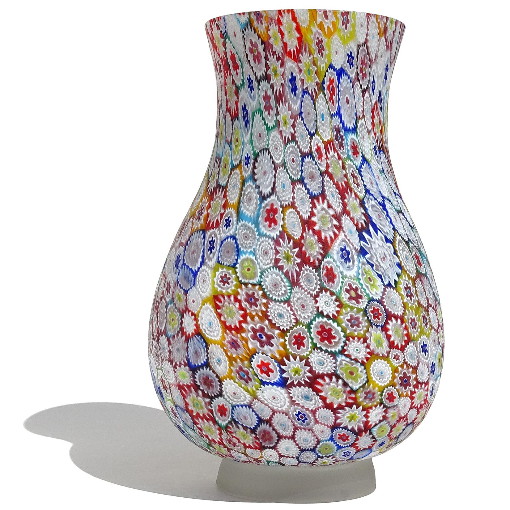 Beautiful, and large, vintage Murano hand blown rainbow colors Millefiori Murrina flower mosaic Italian art glass satin foot vase. The piece is documented to the Fratelli Toso company. Many pieces like it have been published in his books, and I have