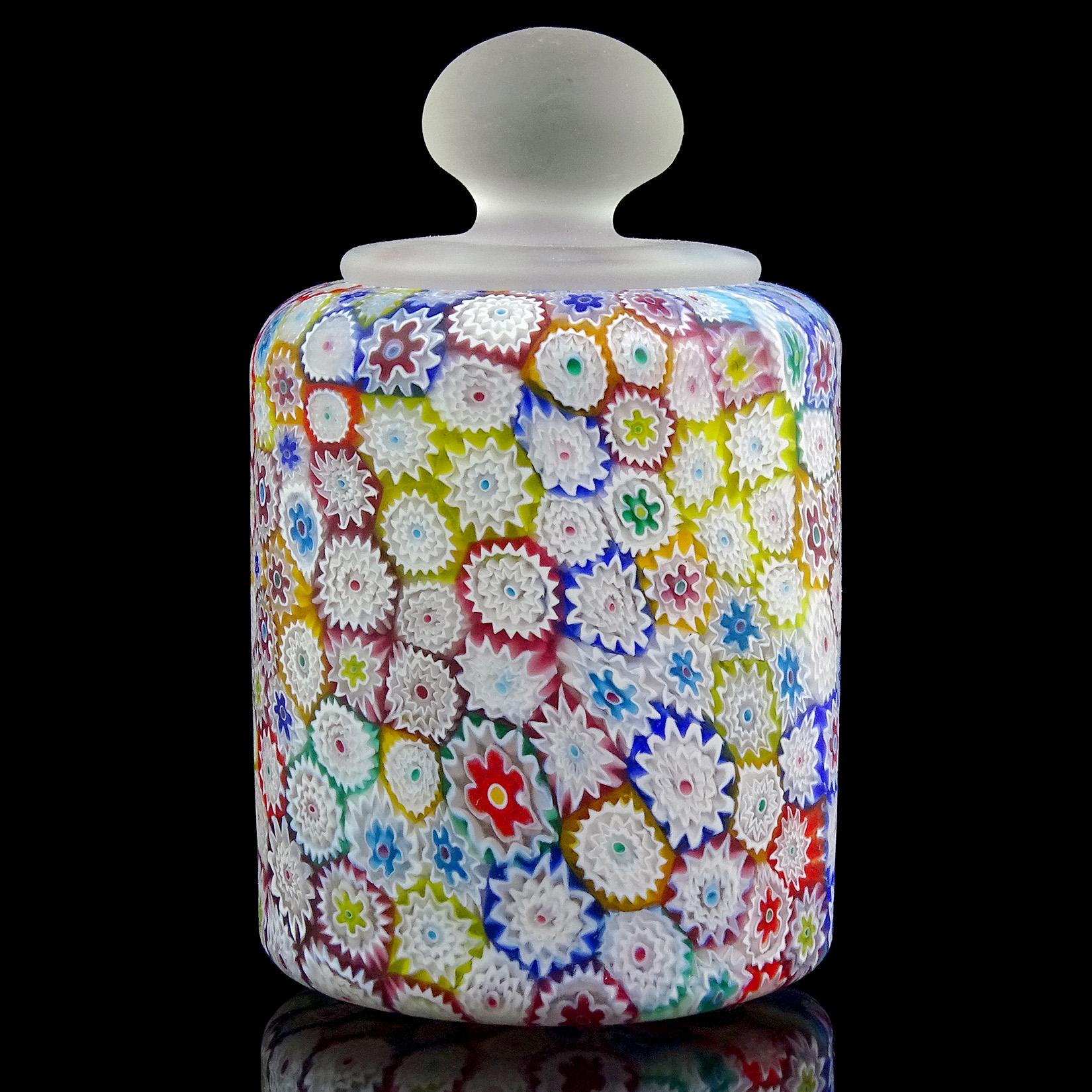 Beautiful Murano handblown millefiori rainbow colors flower mosaic Italian art glass paperweight. Documented to the Fratelli Toso company. It has a clear handle at the top, with satin surface. Measures 5