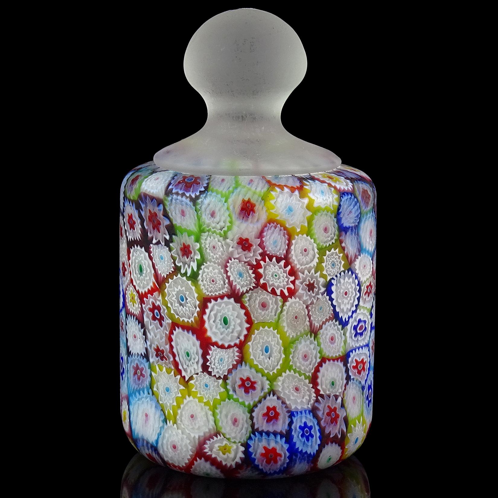 Beautiful vintage Murano hand blown millefiori rainbow colors flower mosaic Italian art glass paperweight. Documented to the Fratelli Toso company. It has a clear handle at the top, with satin surface. The paperweight has a great array of colors,