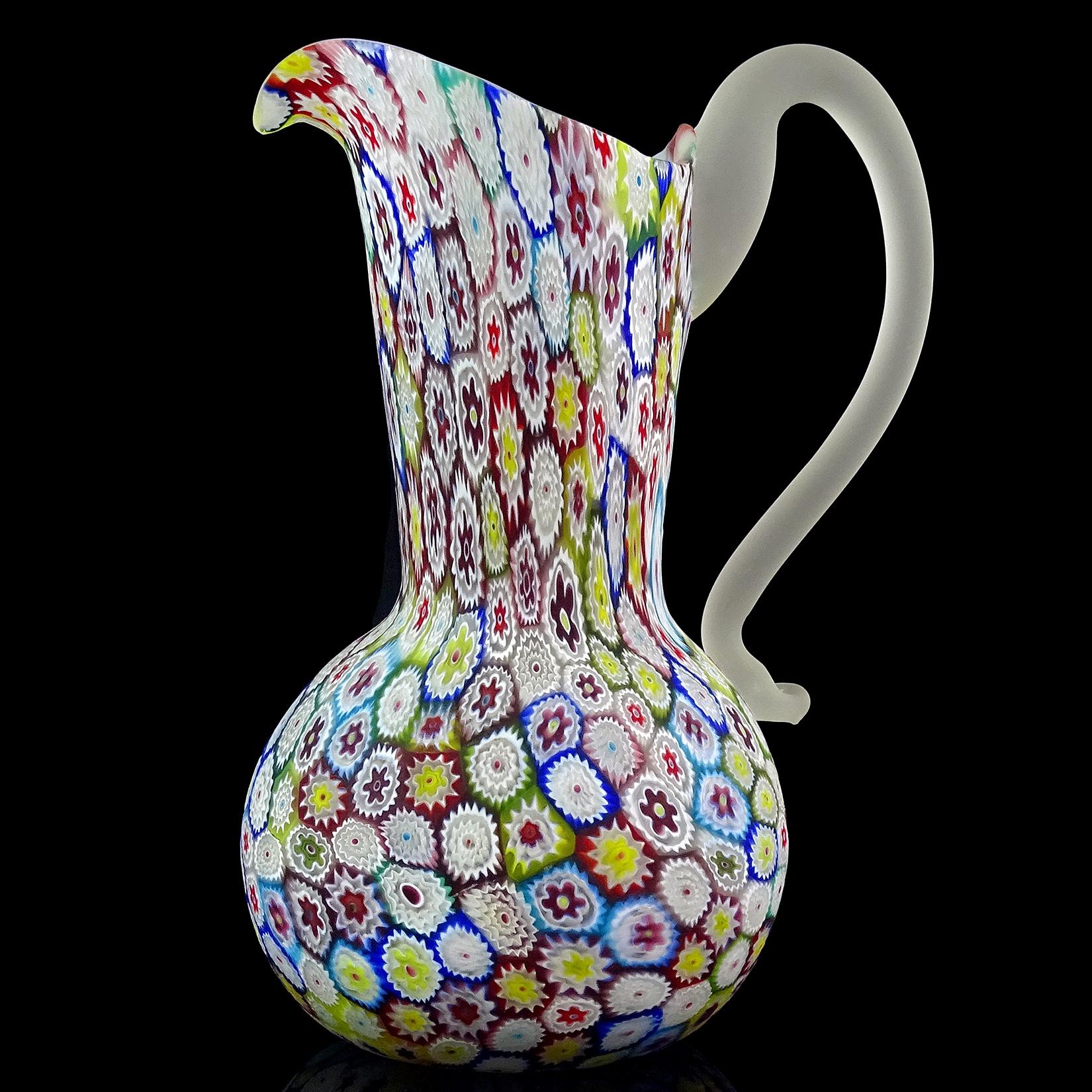 Beautiful vintage Murano hand blown millefiori, rainbow colors, flower mosaic Italian art glass pitcher / vase. Documented to the Fratelli Toso Company. The piece has a great array of colors, with white, cobalt blue, sky blue, green, yellow, bright