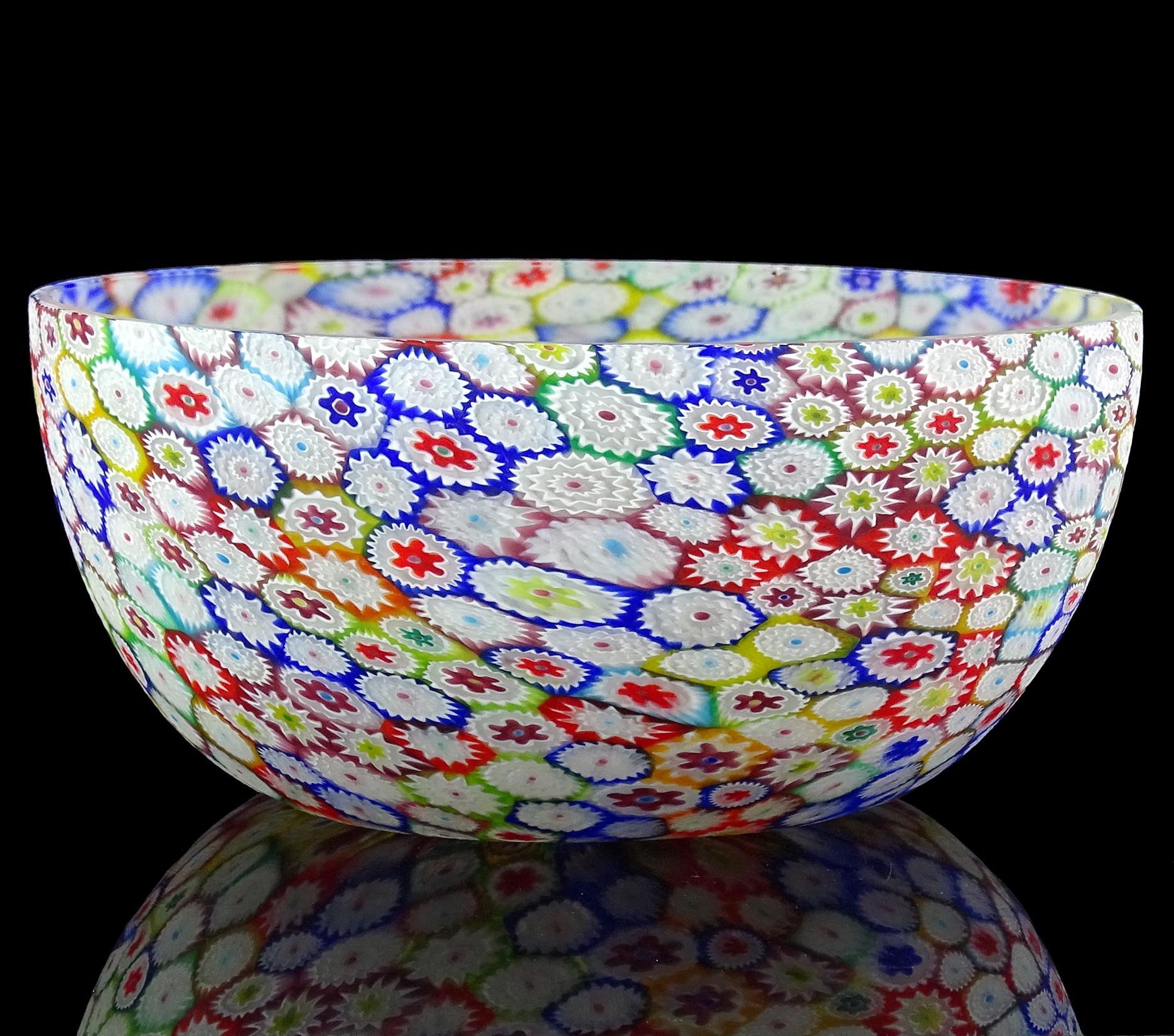 Beautiful large vintage Murano hand blown millefiori, rainbow colors, flower mosaic Italian art glass centerpiece tall bowl. Documented to the Fratelli Toso Company. The bowl has an array of colors, with white, cobalt blue, sky blue, green, yellow,
