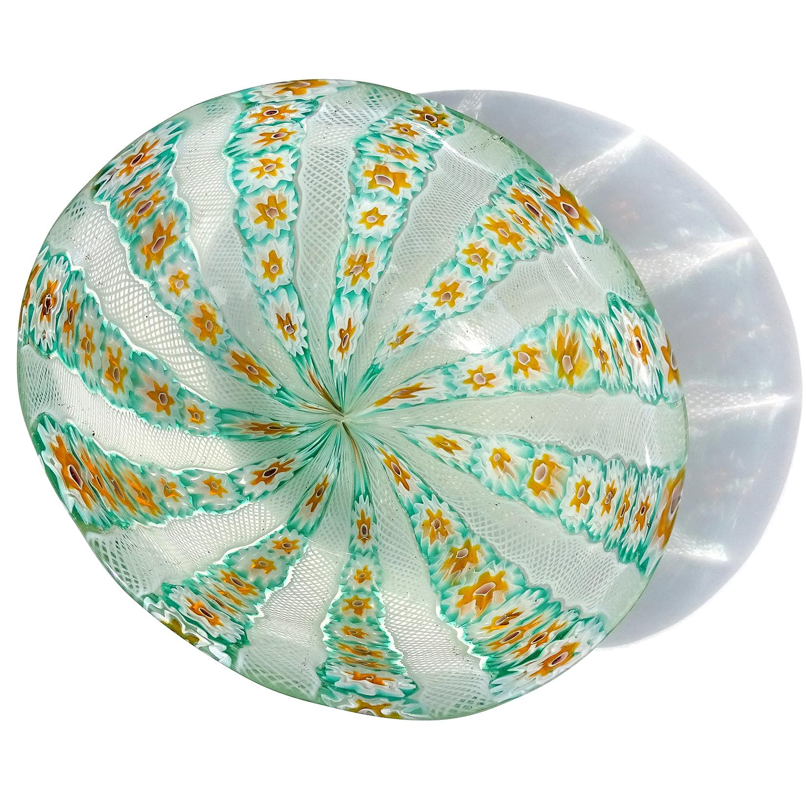 Beautiful vintage Murano handblown millefiori flower mosaic and white net ribbons Italian art glass bowl. Documented to the Fratelli Toso company. The piece has a green, white and orange color combination, with the center of the flowers in pink. The