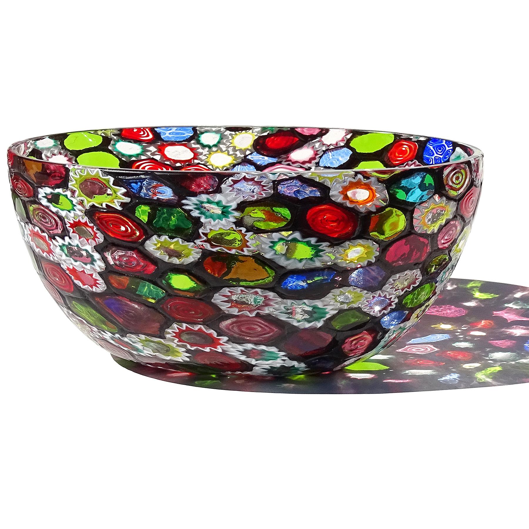 Beautiful large vintage Murano hand blown millefiori flower and star mosaic Italian art glass centerpiece tall bowl. Documented to the Fratelli Toso Company. Many of the murrines are lined in opal white, and some others that are more intricate are