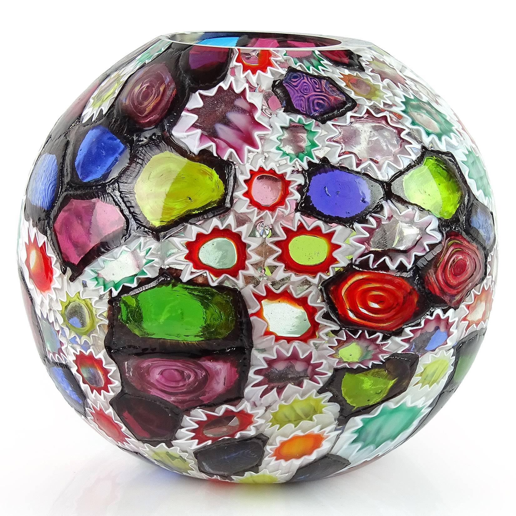 Gorgeous Murano hand blown multi-color Millefiori flower and star mosaic Italian art glass flower vase. Documented to the Fratelli Toso company. Many of the murrines are lined in white, while others are lined in metallic black. Measures 4 3/4” tall