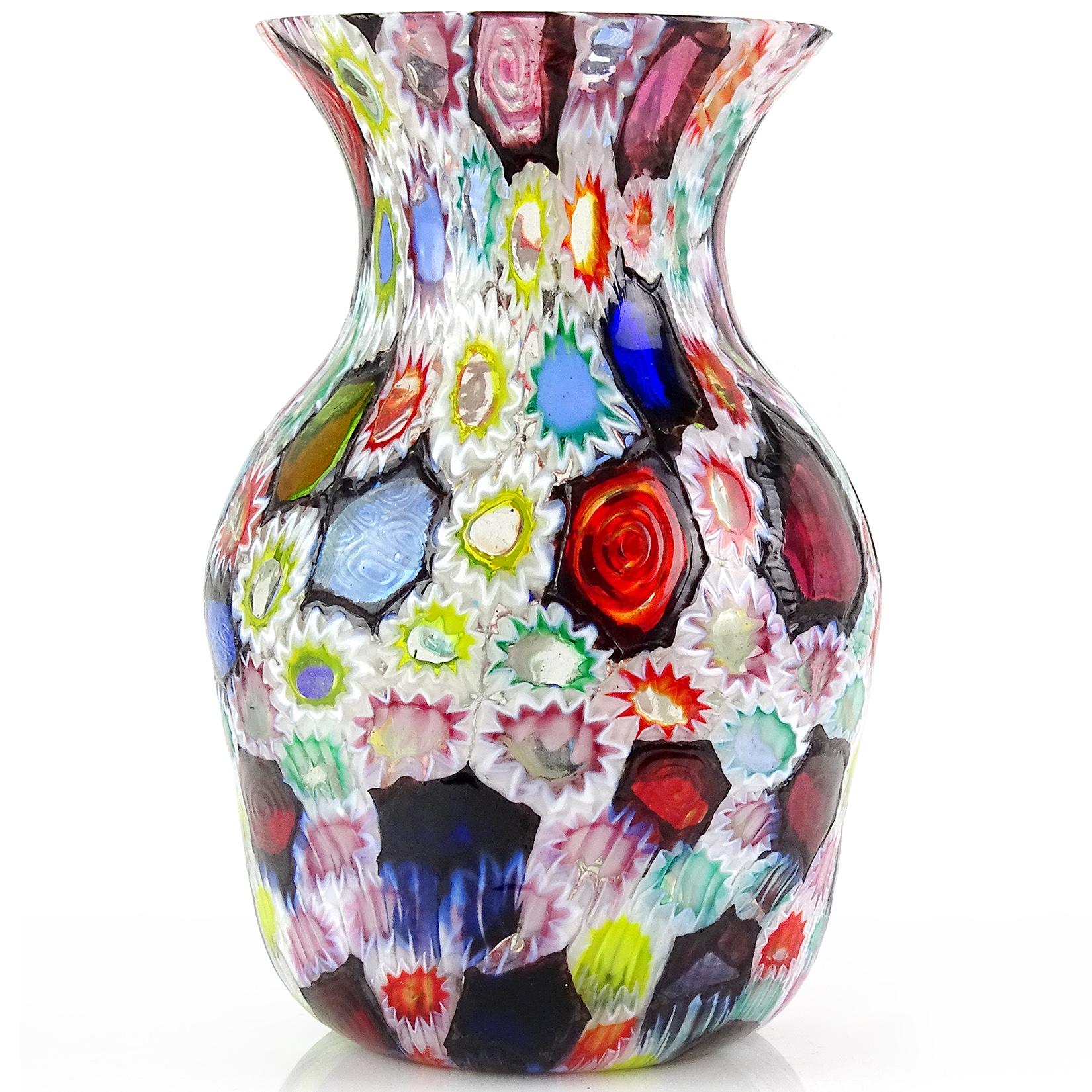 Gorgeous Murano handblown multi-color Millefiori flower and star mosaic Italian art glass flower vase. Documented to the Fratelli Toso company. Many of the murrines are lined in opal white, and some are lined in metallic black. Has blue, red, pink,