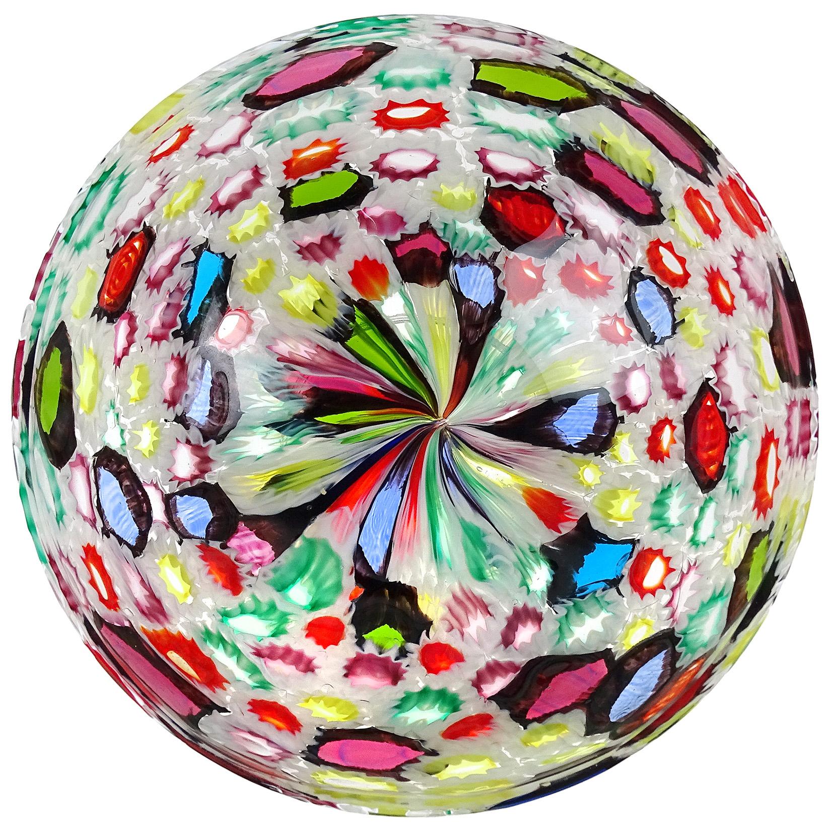 Beautiful Murano hand blown multi-color Millefiori flower and star mosaic Italian art glass circular footed bowl. Documented to the Fratelli Toso Company. Many of the murrines are lined in opal white, and some are lined in a metallic black.